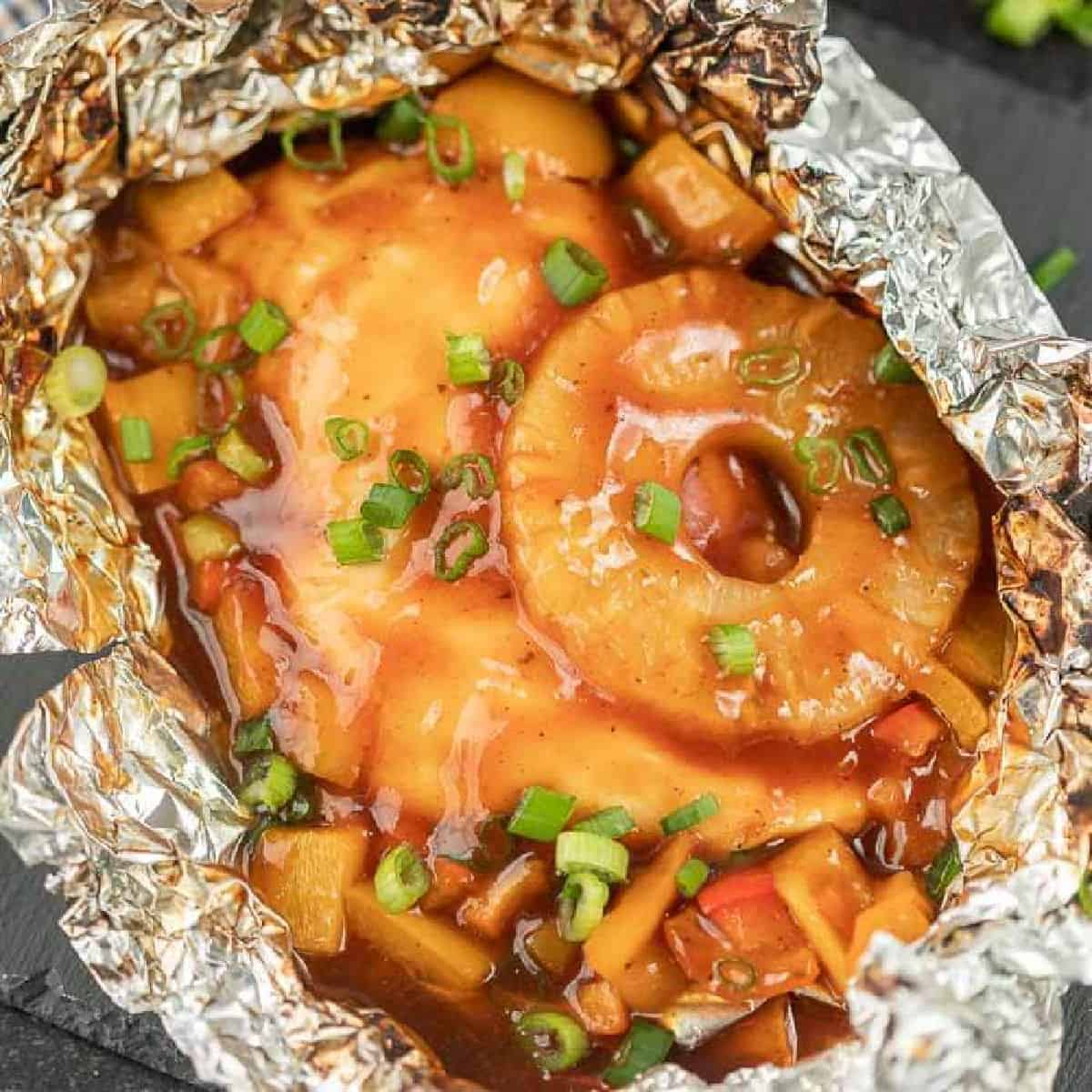 Foil Packet Hawaiian BBQ Chicken Recipe is perfect for the grill, campfire, or oven.  Everyone will love the combination of sweet and tangy. 