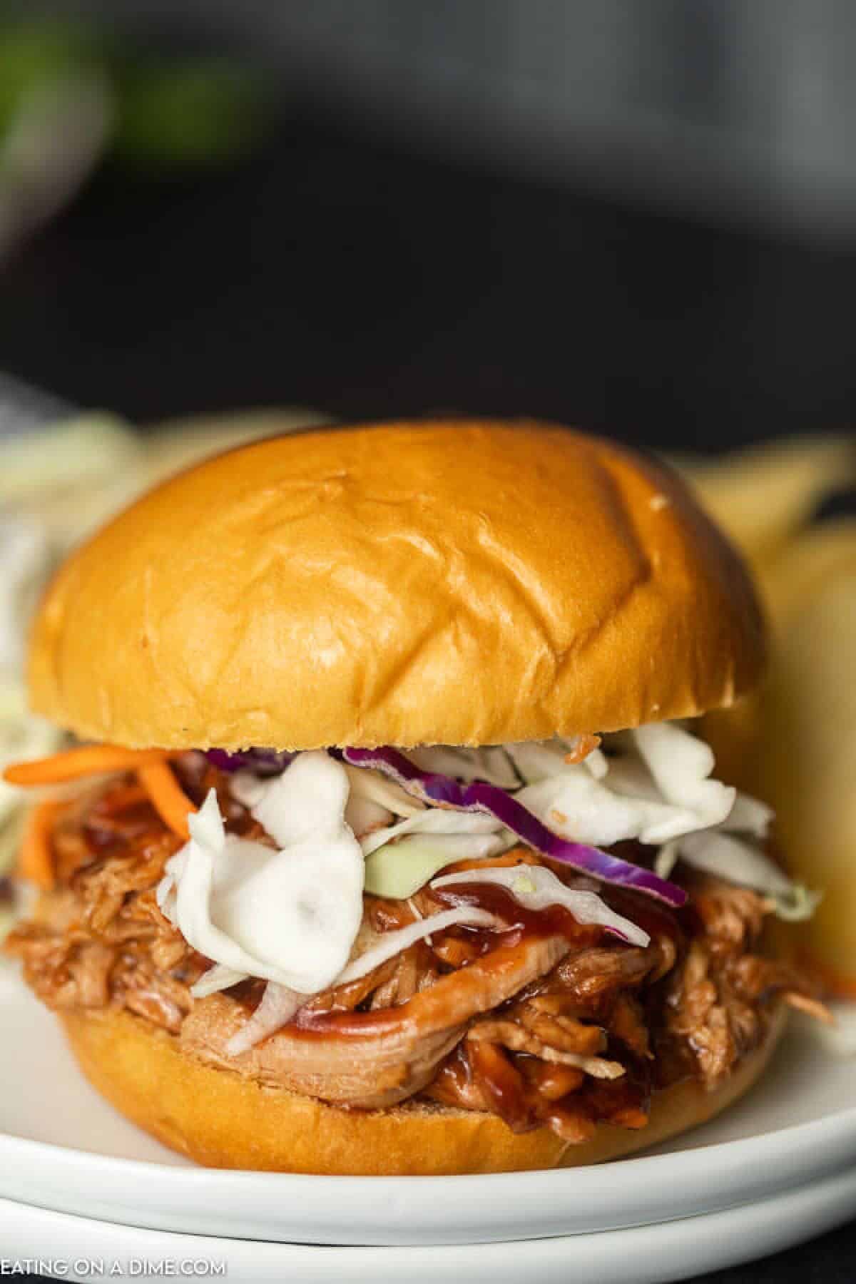 Instant pot pulled pork recipe is a quick and easy dinner idea! There is lots of tender pork packed with flavor piled high on a fluffy roll! 