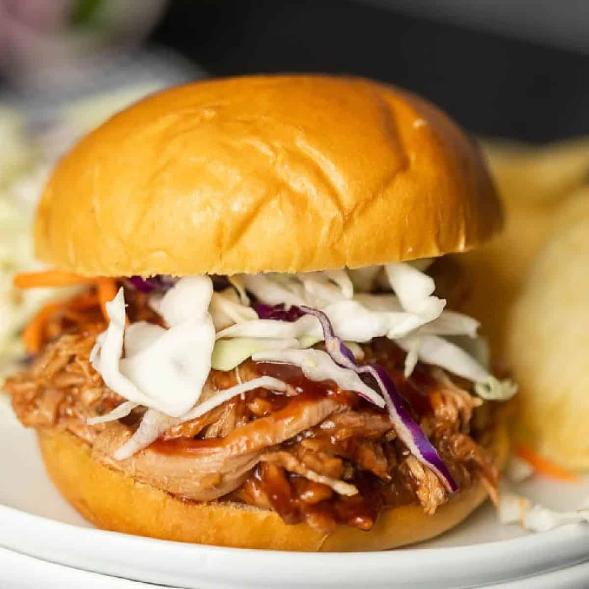 Instant pot pulled pork recipe is a quick and easy dinner idea! There is lots of tender pork packed with flavor piled high on a fluffy roll! 