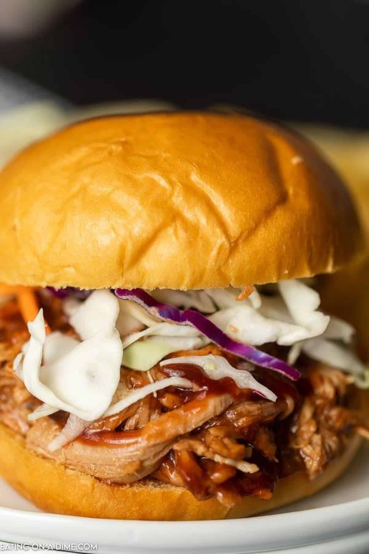 Instant pot pulled pork recipe is a quick and easy dinner idea! There is lots of tender pork packed with flavor piled high on a fluffy roll! 