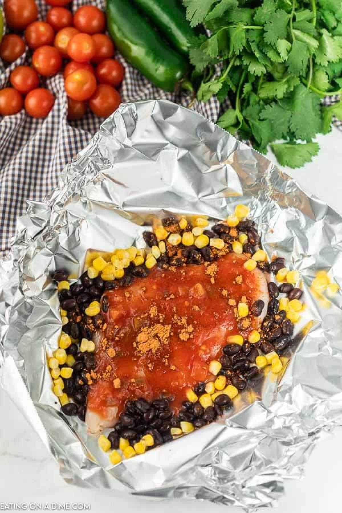 Santa fe Chicken foil pack has everything you need for a great dinner. Cheesy chicken, black beans, corn and even rice!