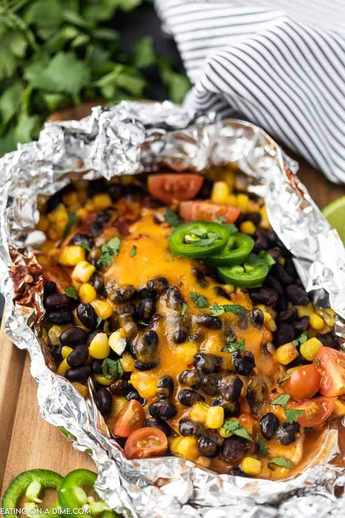 Santa fe Chicken foil pack has everything you need for a great dinner. Cheesy chicken, black beans, corn and even rice!