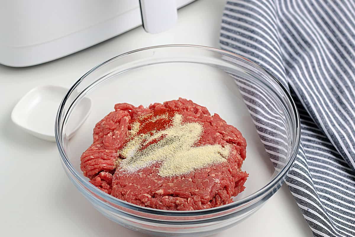Ground beef in a bowl topped with seasoning