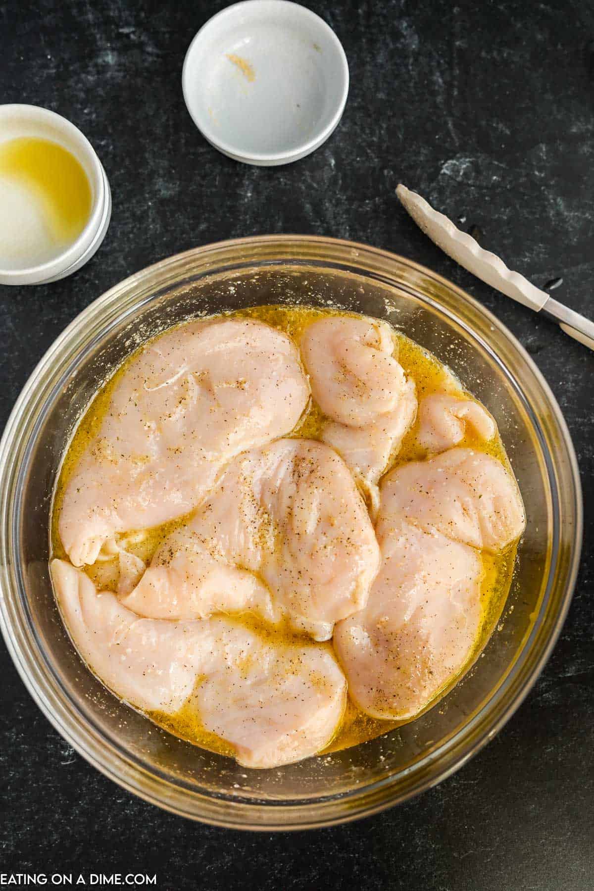 Chicken marinating in a bowl