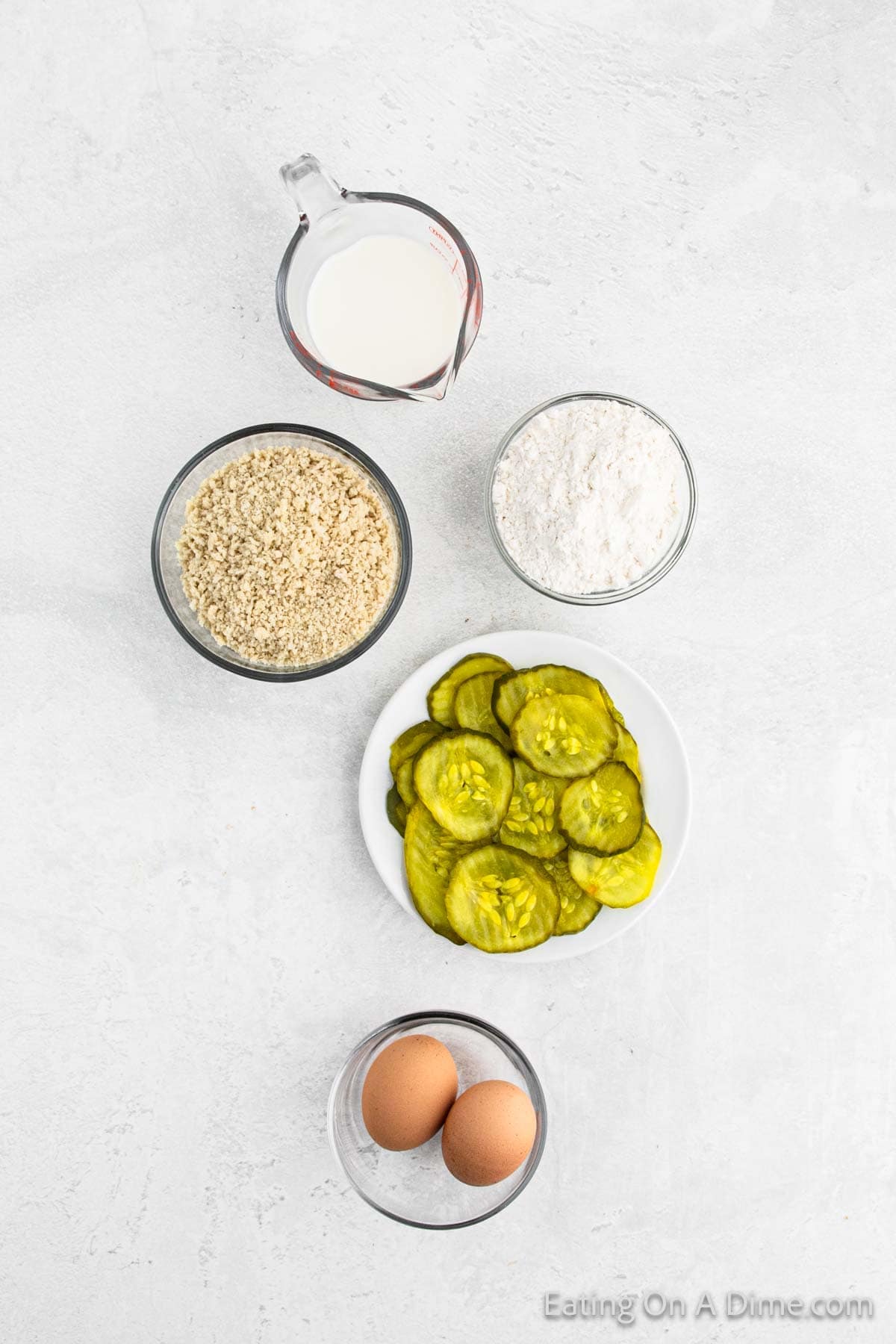 Ingredients, eggs, slice pickles, flour, breadcrumbs, and milk