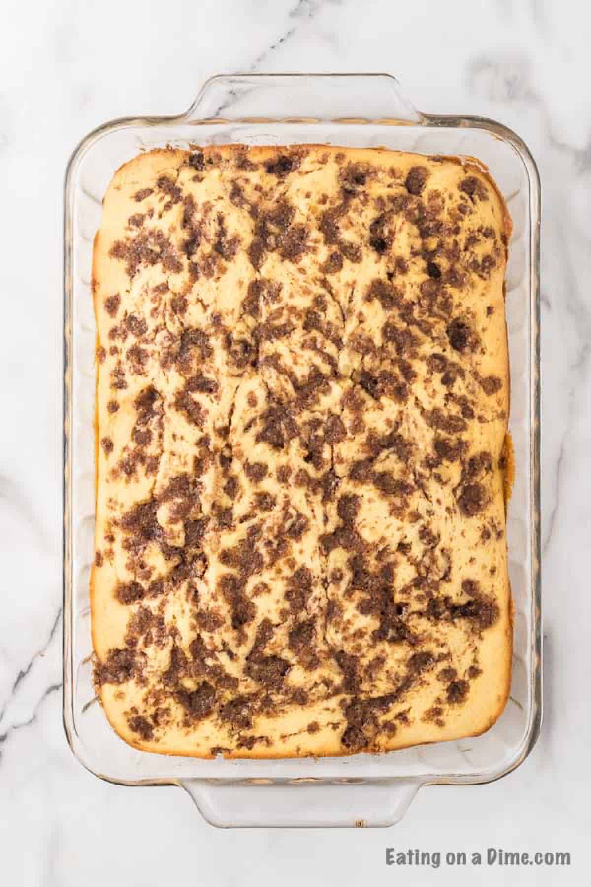 The cake baked and cooling in a pan.  