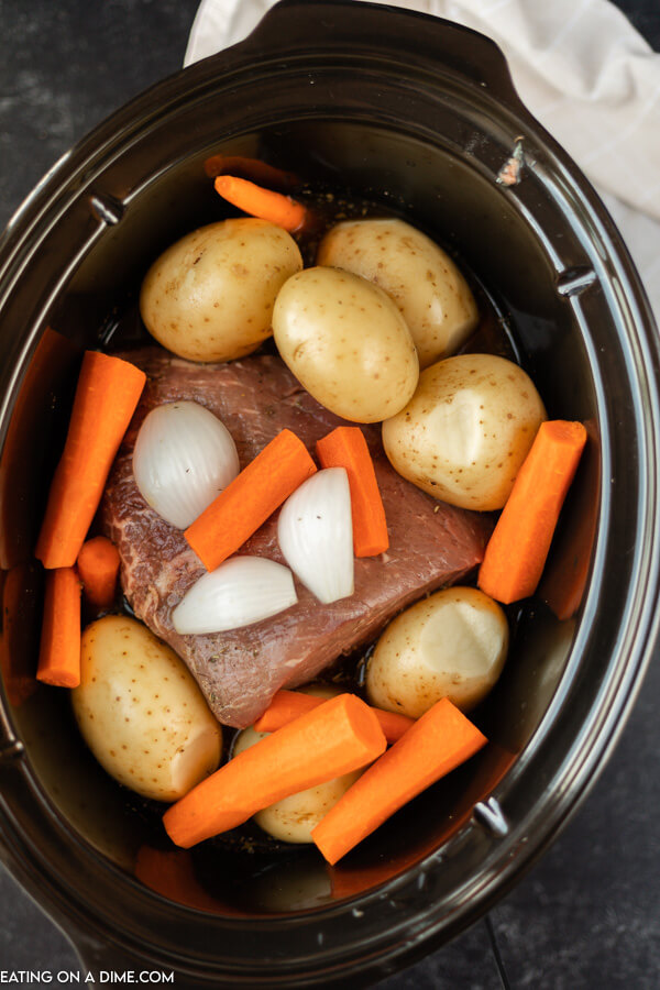 crockpot of roast, potatoes, onion and carrots