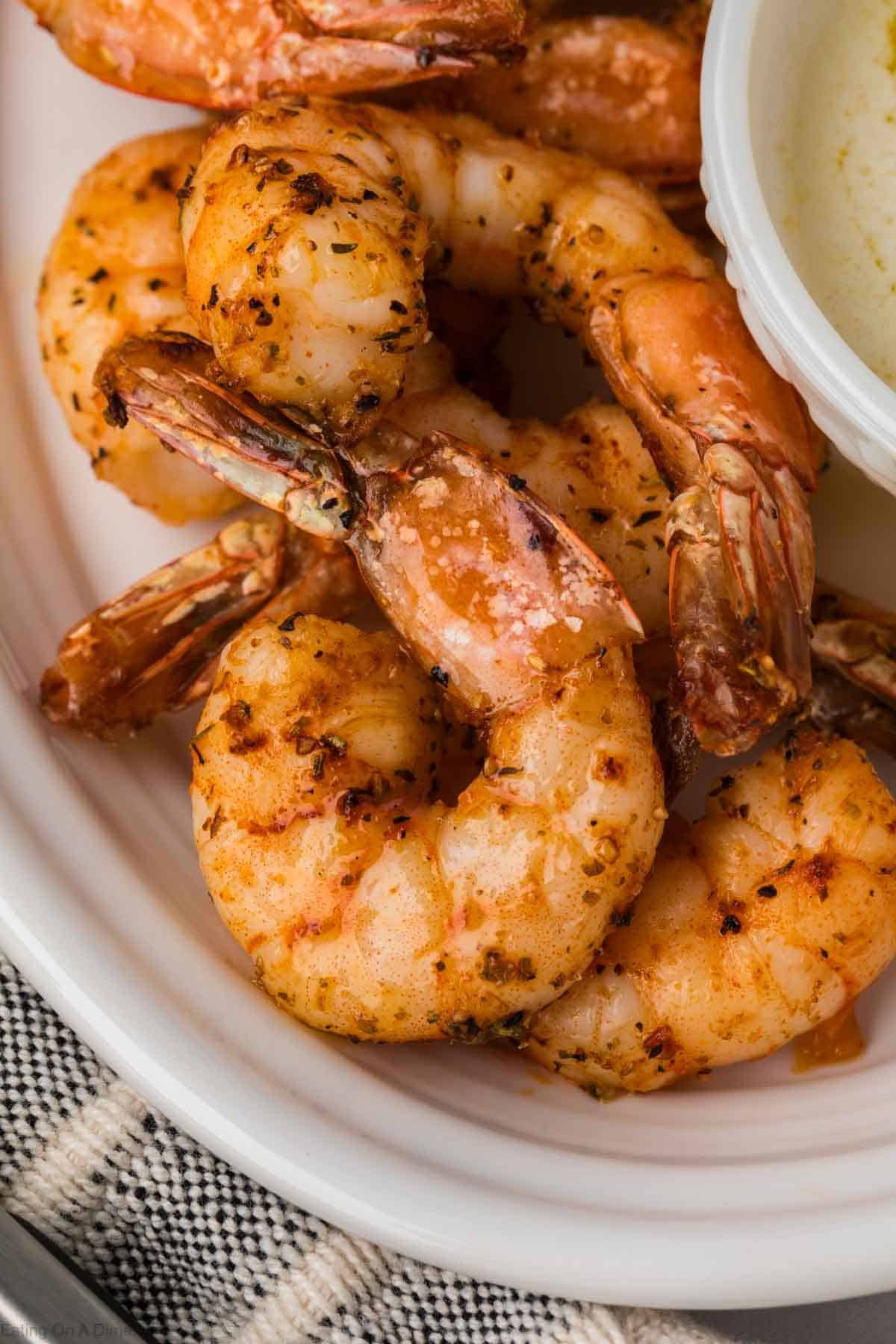 Air Fryer Shrimp on a platter with a small bowl on the side