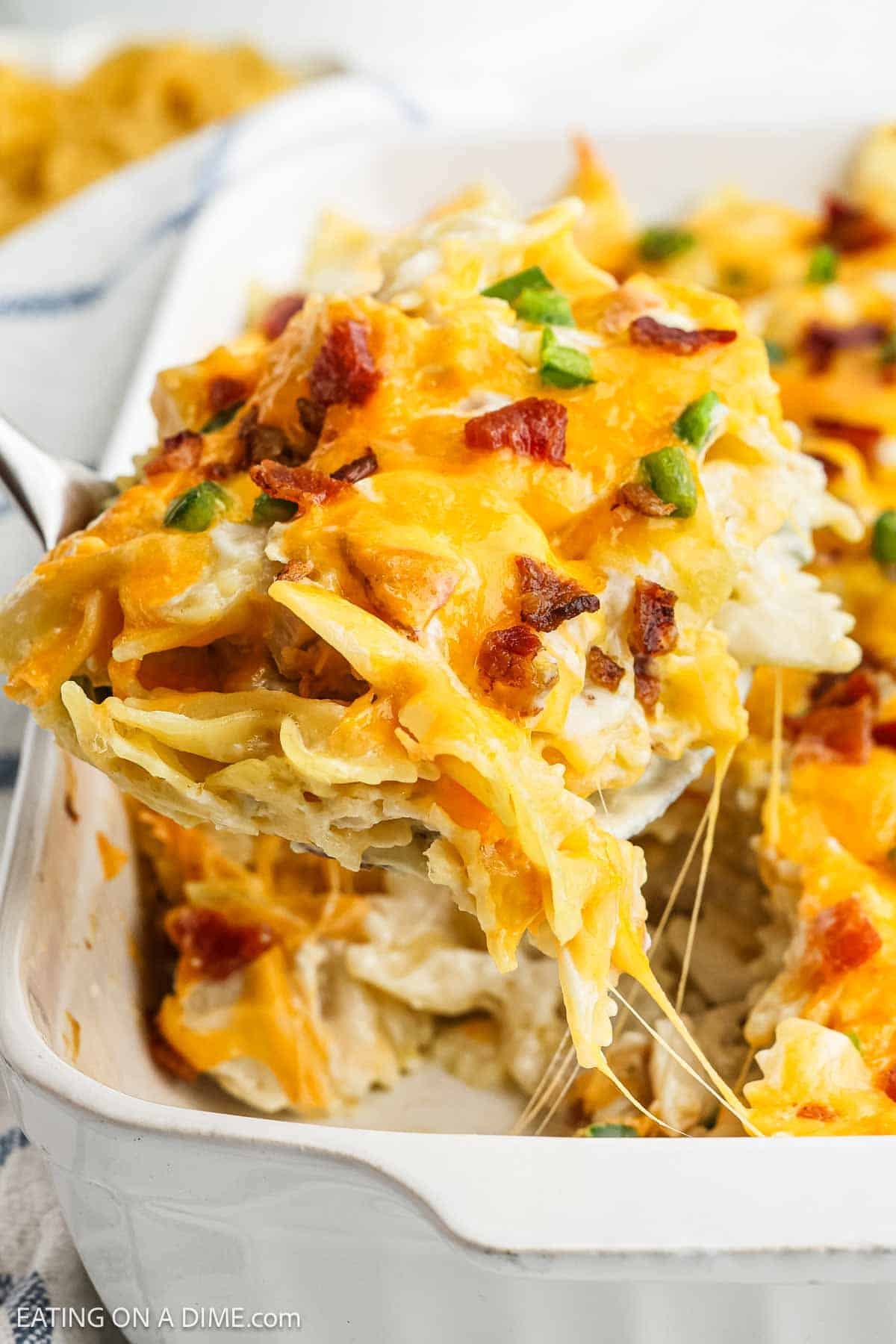 A serving of the Jalapeno Popper Chicken Casserole topped with melted cheese, chopped bacon and Jalapeno