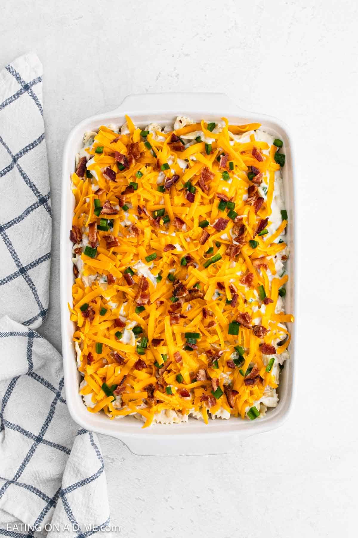 Shredded cheese, chopped bacon and diced jalapenos topped the casserole mixture in a casserole dish