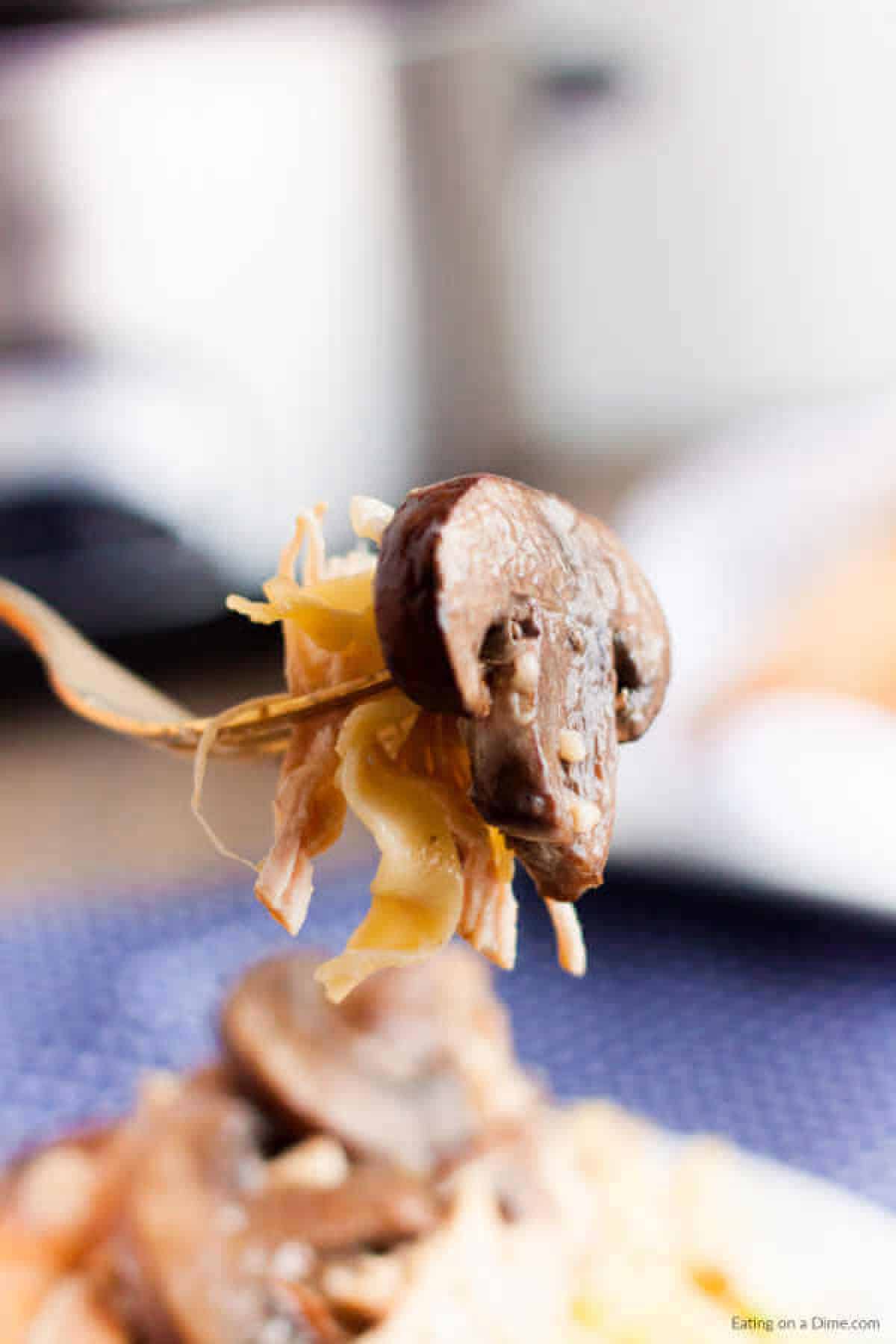 bite of chicken marsala on a fork