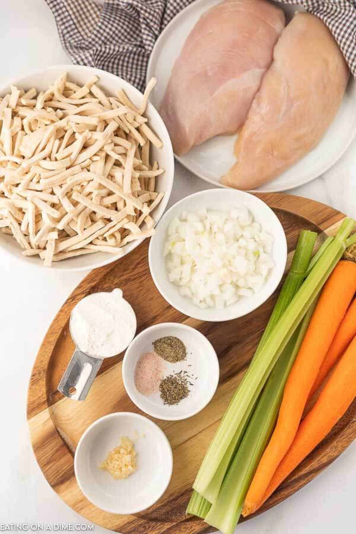 Ingredients - Chicken, onion, celery, carrots, thyme, garlic, pepper, salt, flour, water, broth, frozen noodles