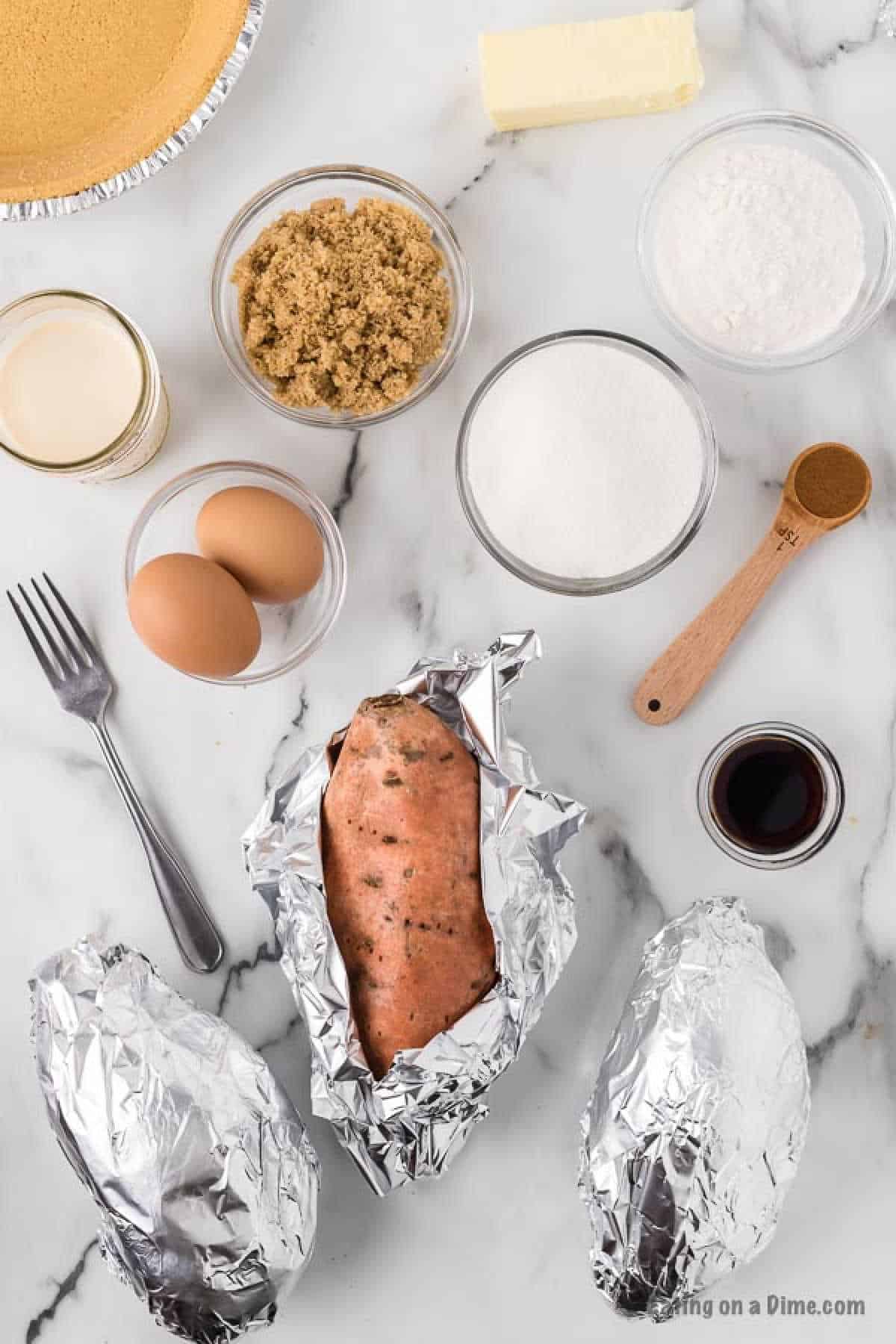 Sweet potatoes wrapped in foil with small bowls of eggs, brown sugar, flour, sugar, vanilla and cinnamon