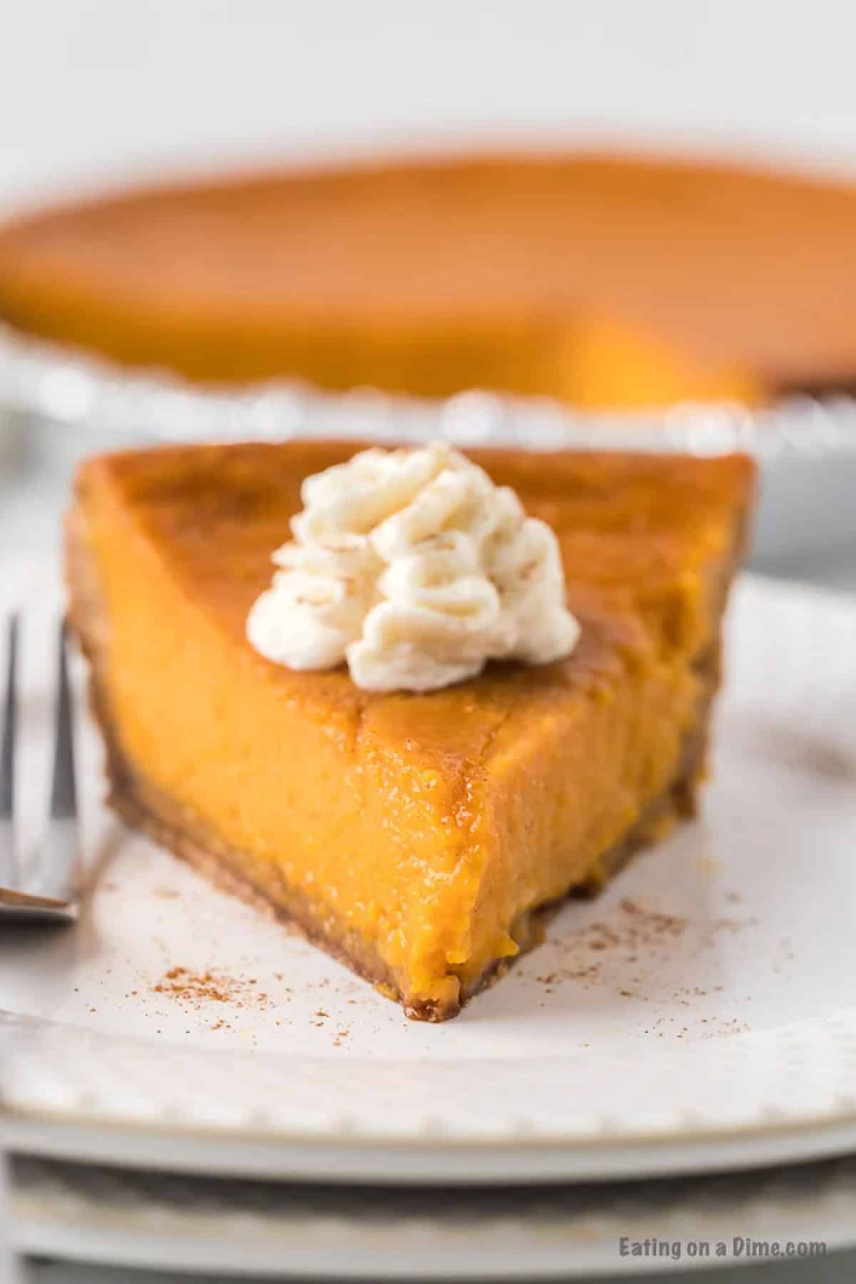 Slice of sweet potato pie topped with whipped cream