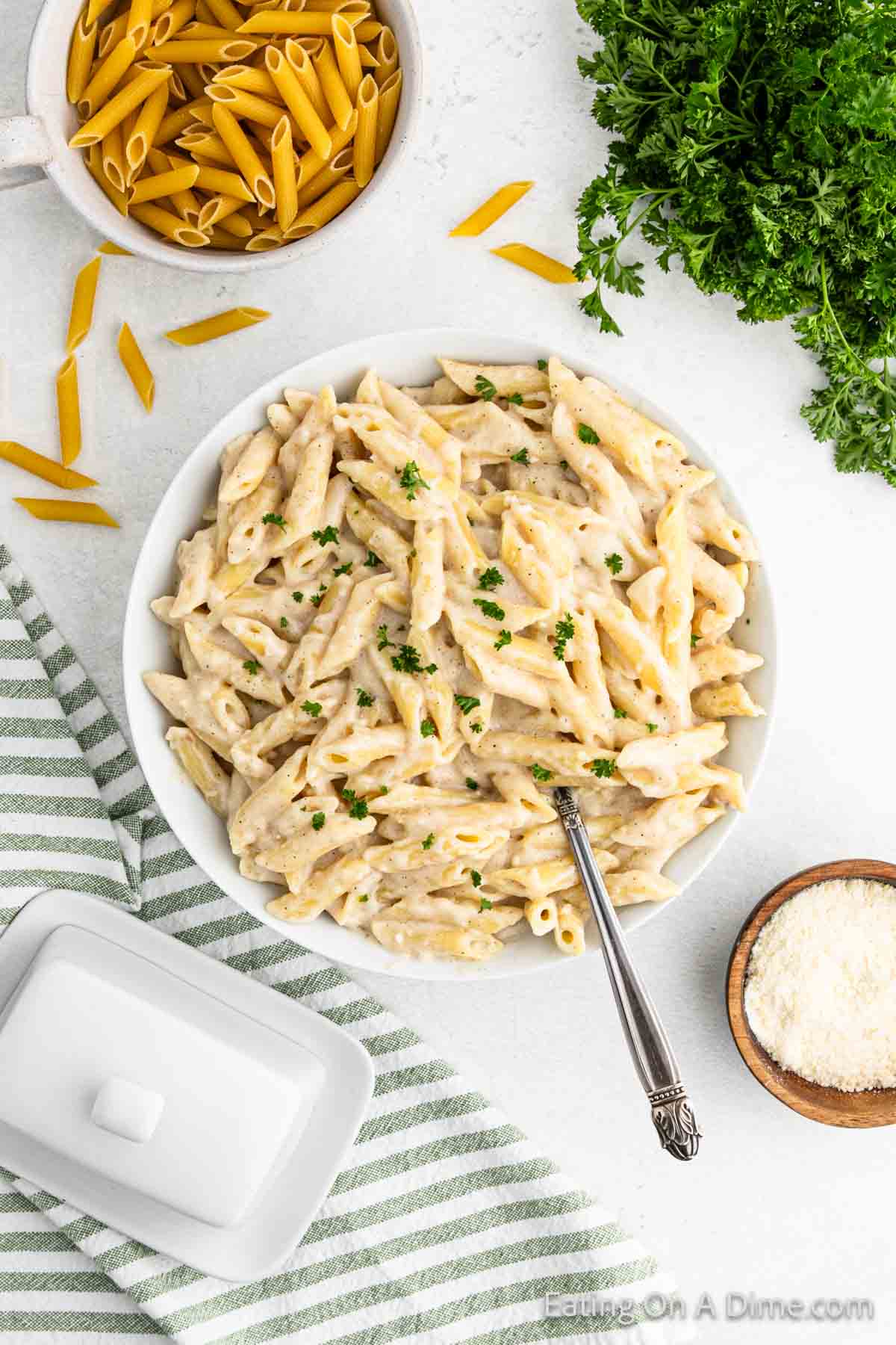 Penne pasta in a bowl mixed with a creamy sauce in a bowl 