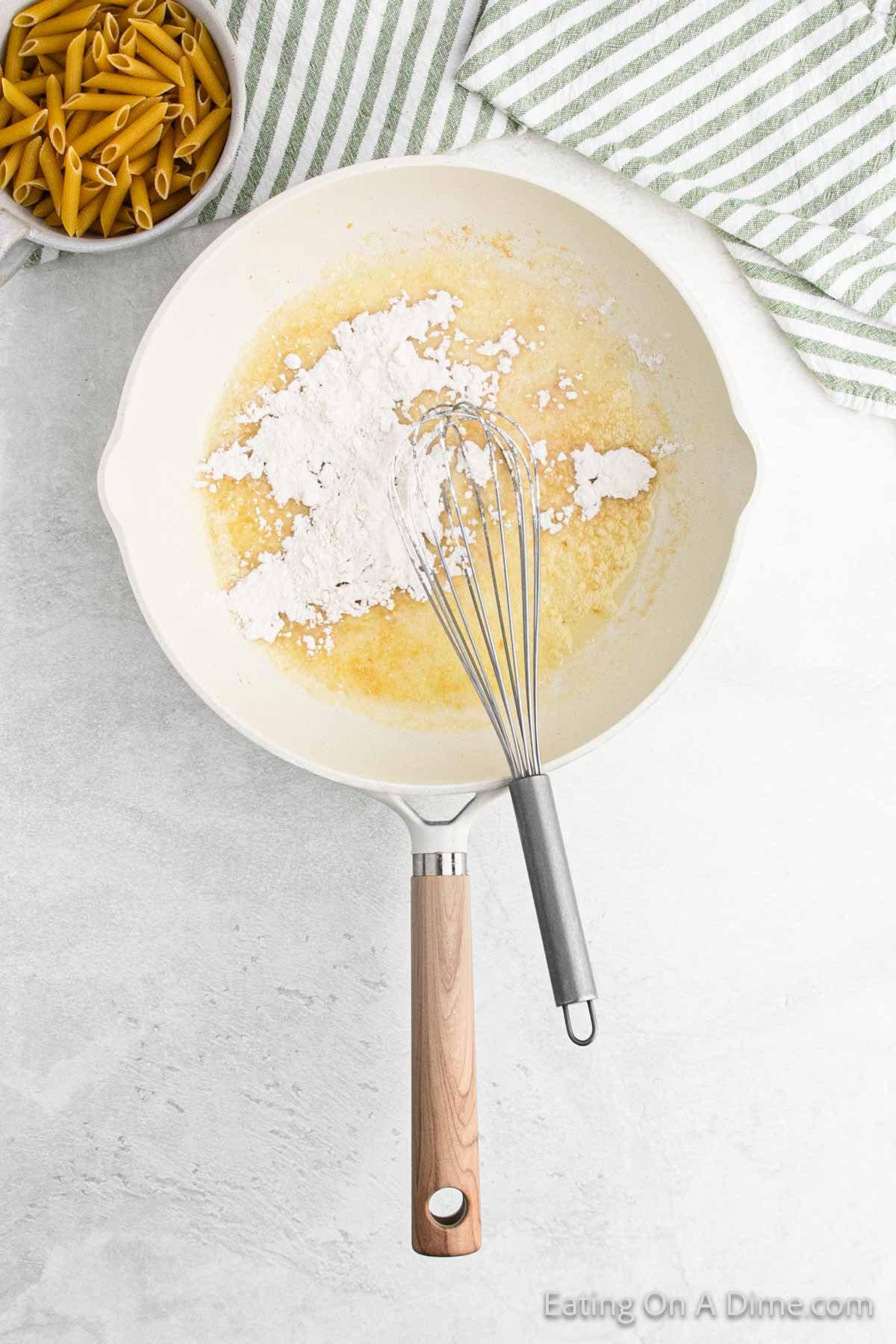 Whisking in flour into the skillet with melted butter