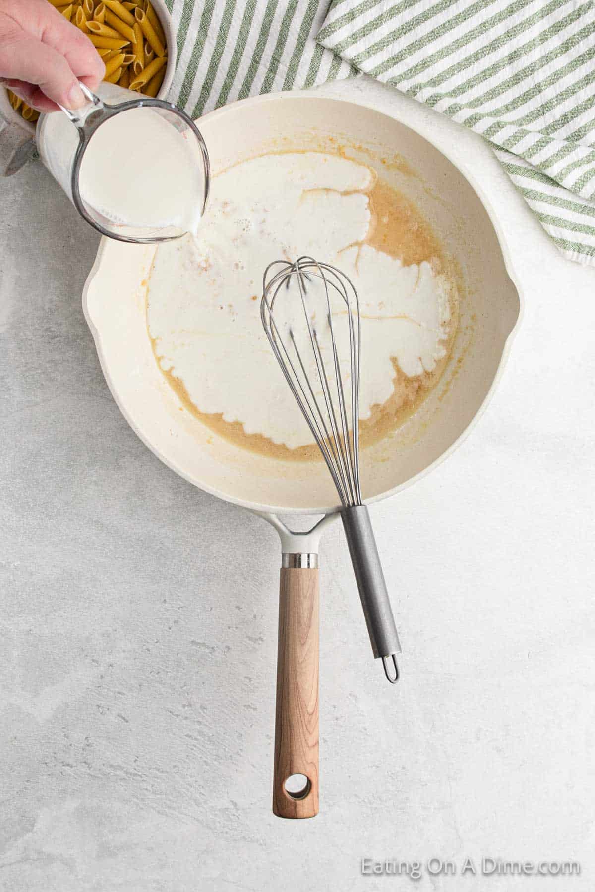 Pouring milk in a skillet with the flour mixture