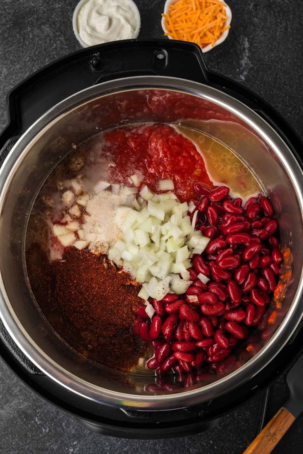 Chopped onions, seasoning, tomato sauce and red kidney beans in the instant pot