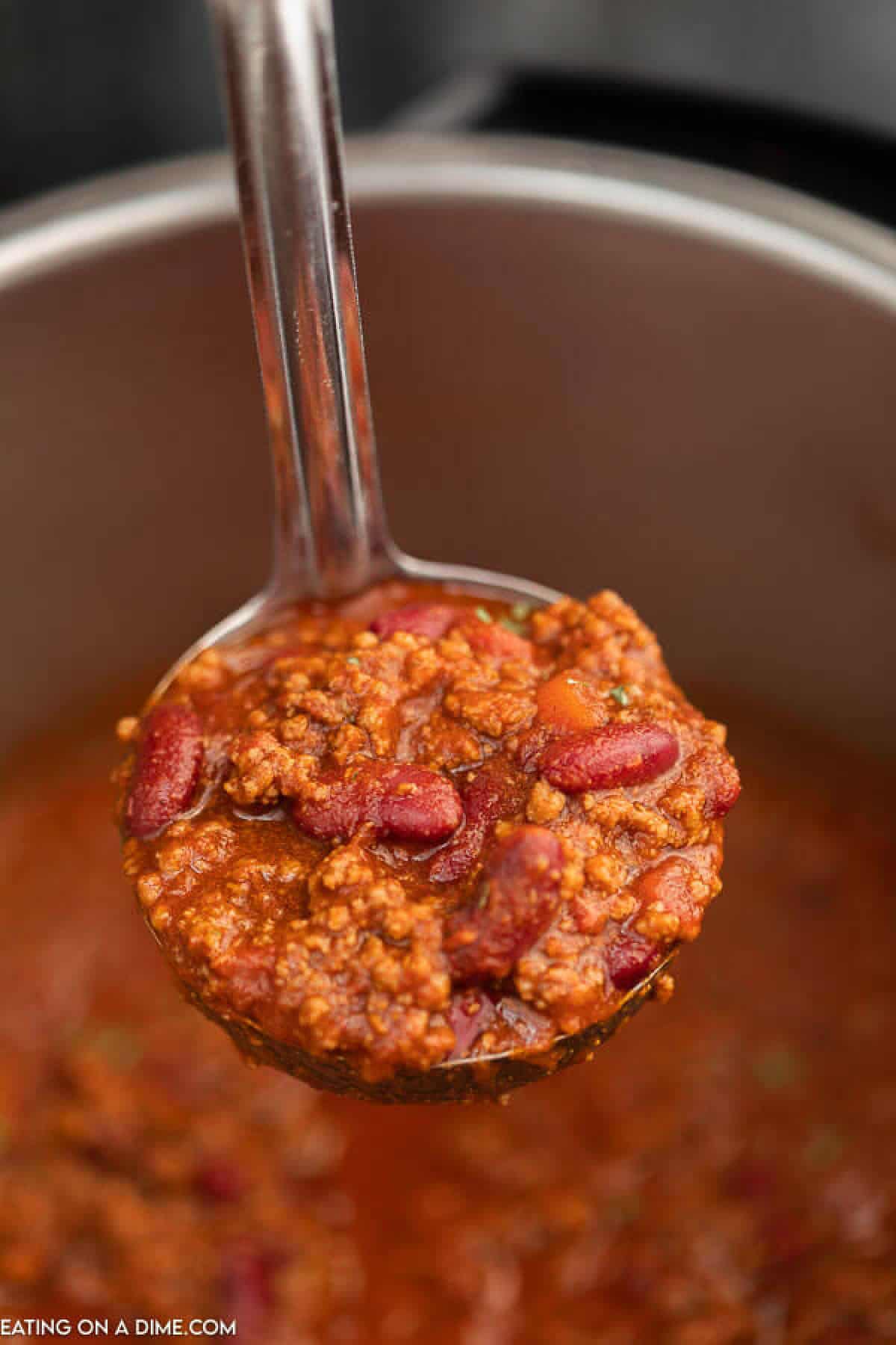 Ladle of chili over instant pot.