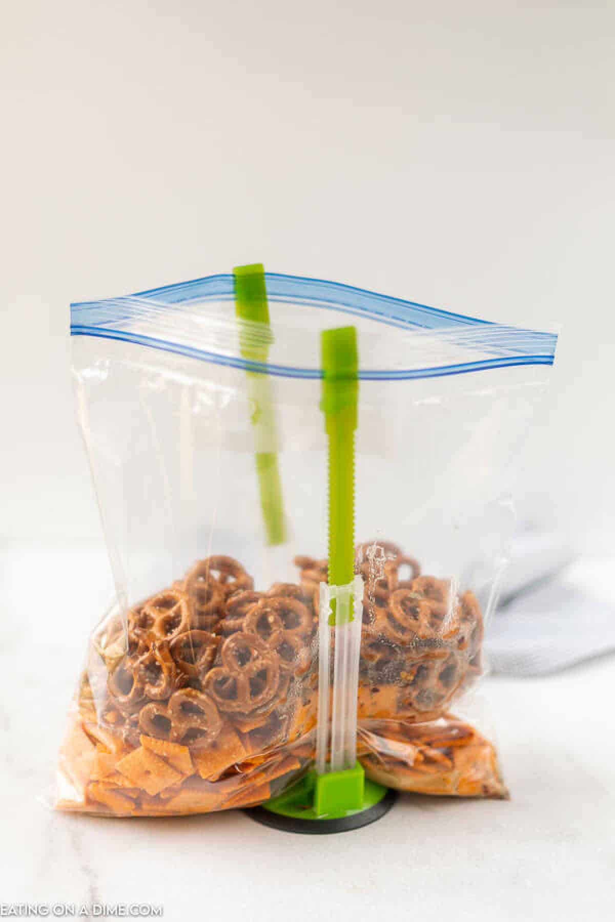 Close up image of in process of making the snack mix in a ziplock. 