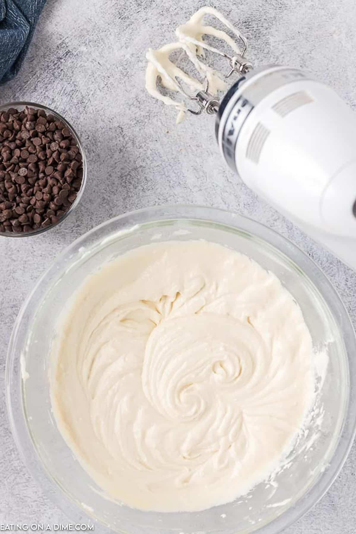 Dip batter in a bottle mixed together with a hand mixer on the side with a bowl of chocolate chips