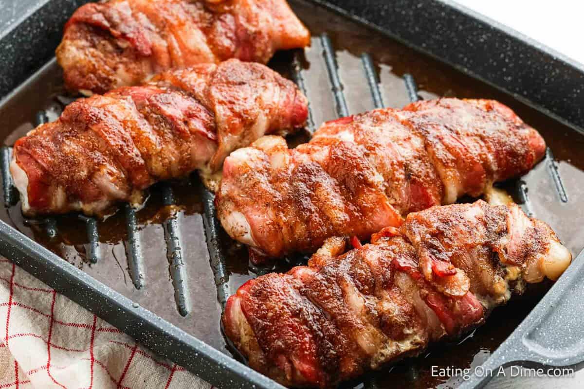 Bacon wrapped chicken in a roasting pan