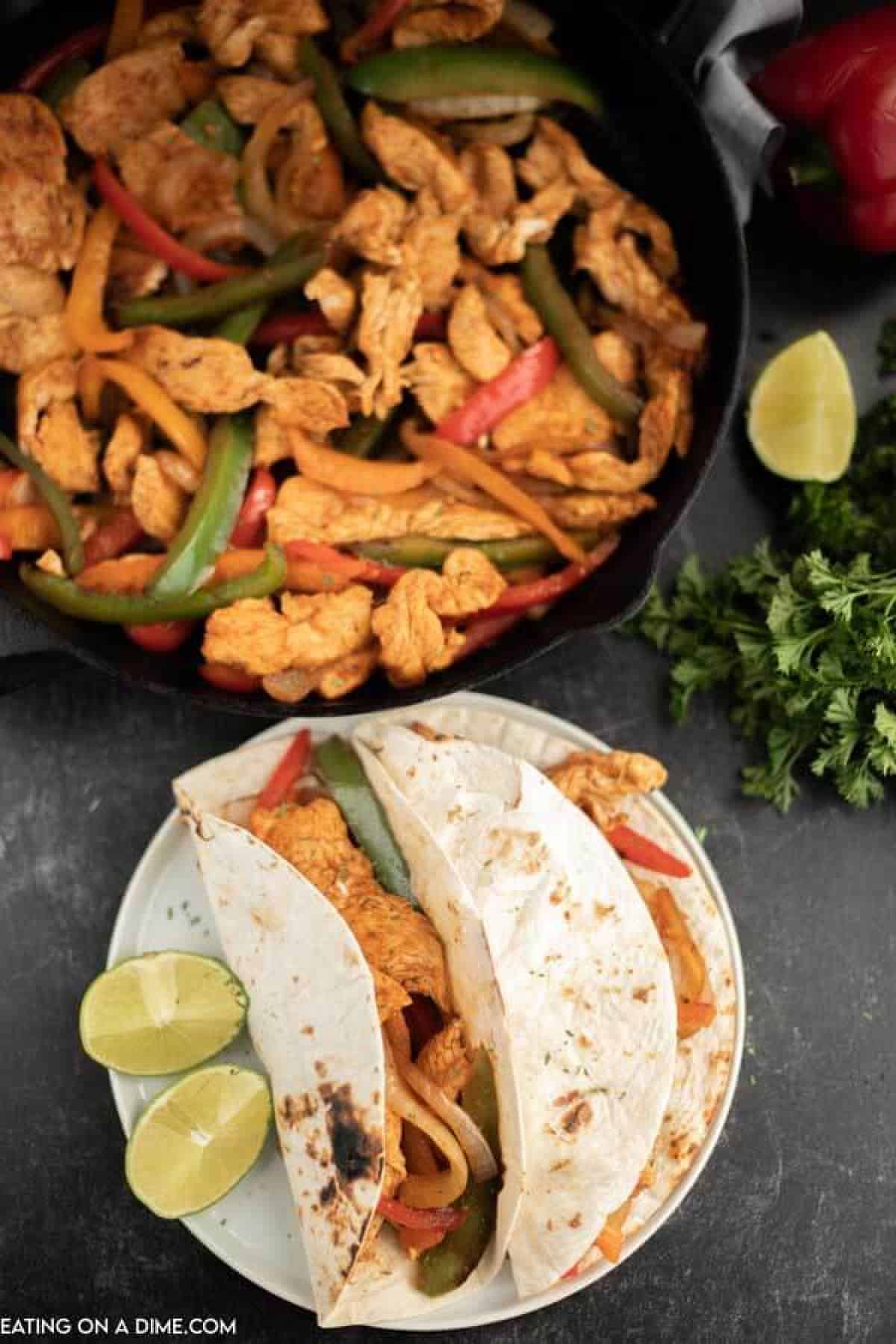 Cast iron skillet of chicken strips, bell peppers and onion. 