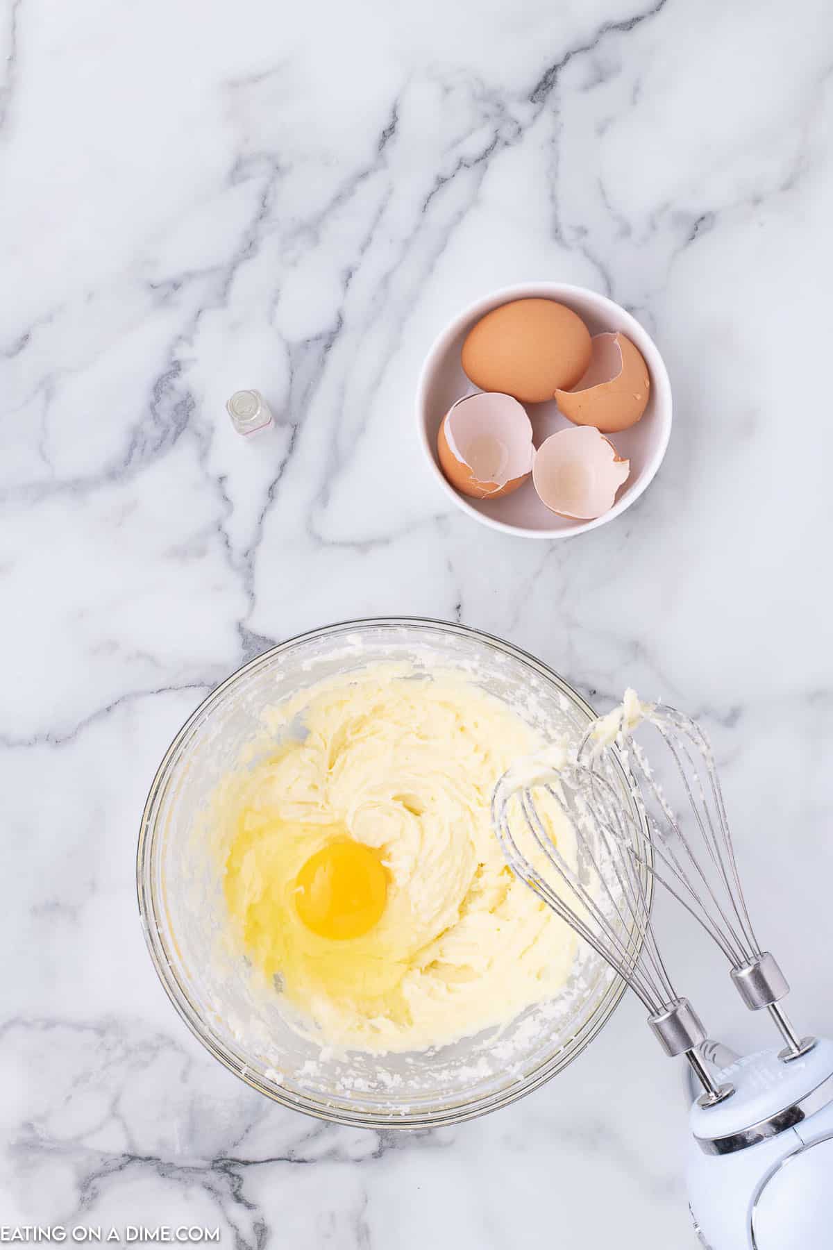 Mix in eggs to the butter mixture in a bowl with a hand mixer