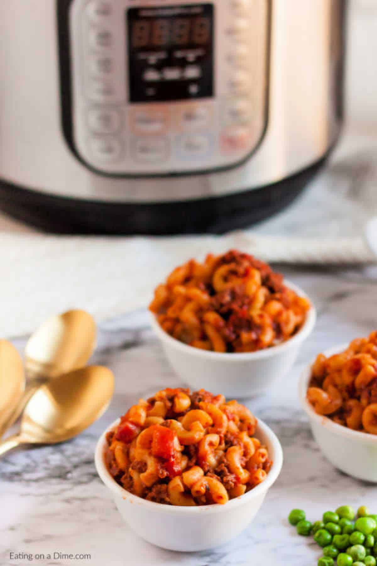 Close up image of goulash in three separate white bowls. 