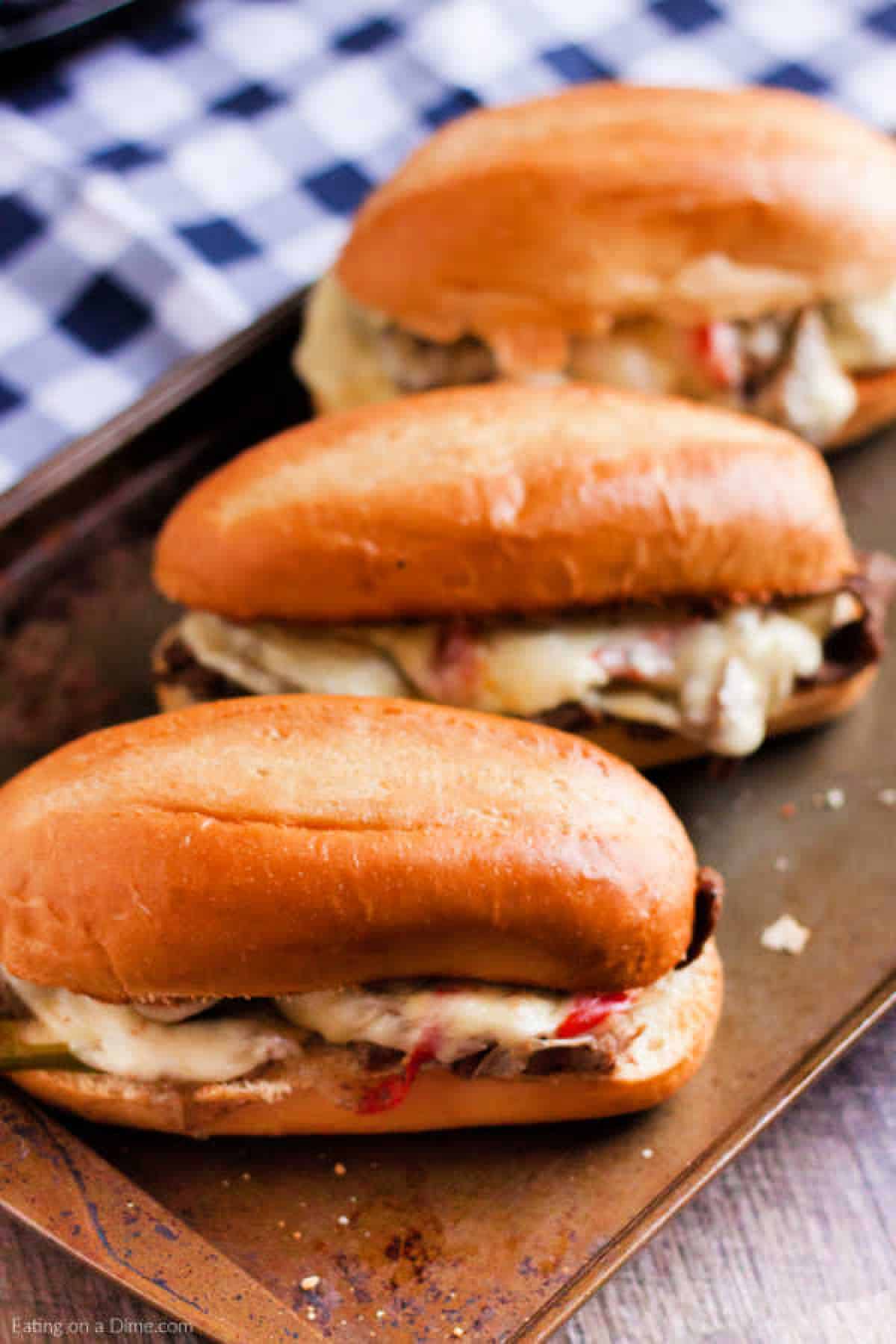 Close up image of philly cheesesteak on a baking sheet. 