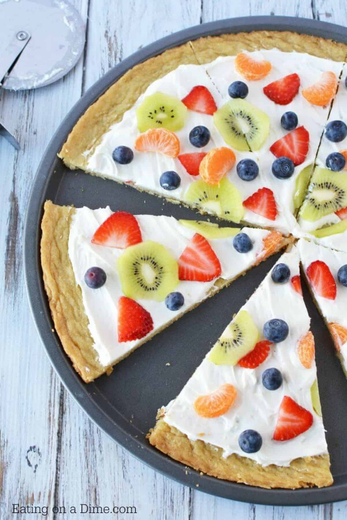 Close up image of a fruit pizza sliced. 