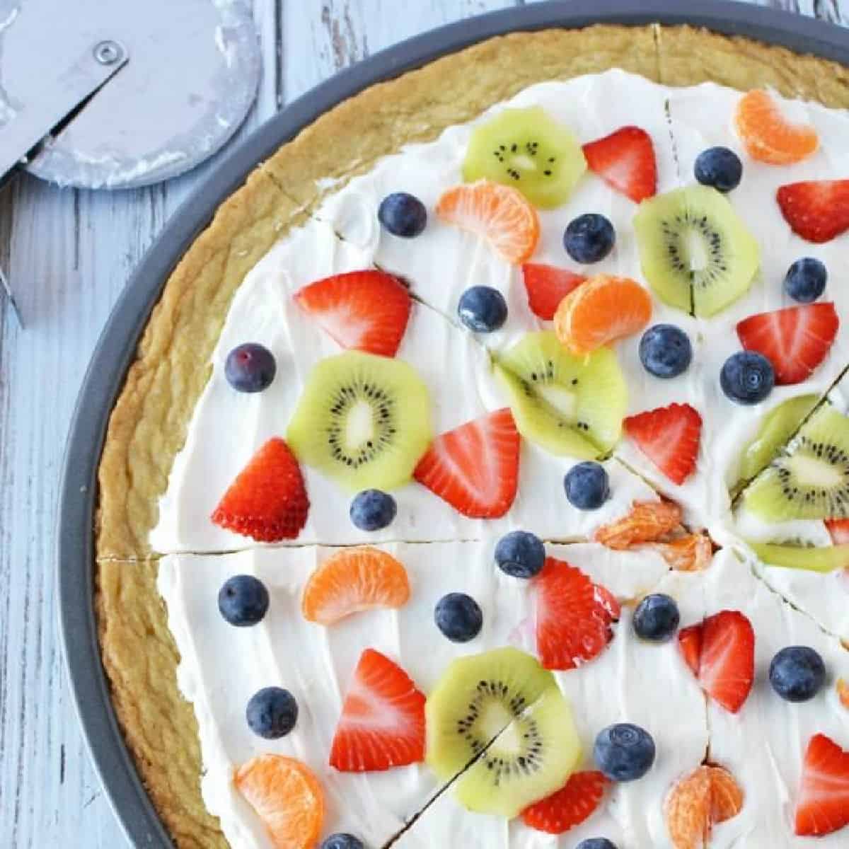 Close up image of a fruit pizza sliced. 