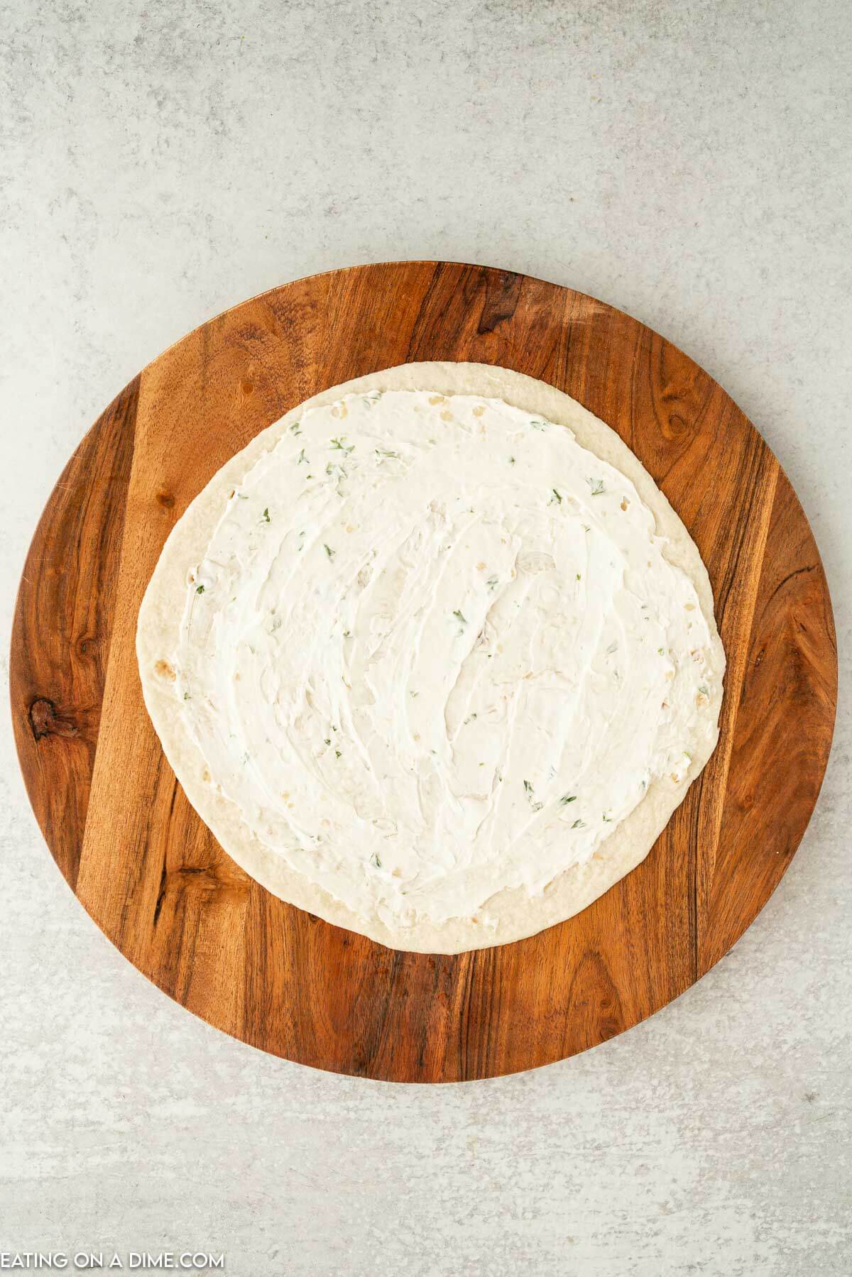 tortilla with cream cheese on a brown platter 