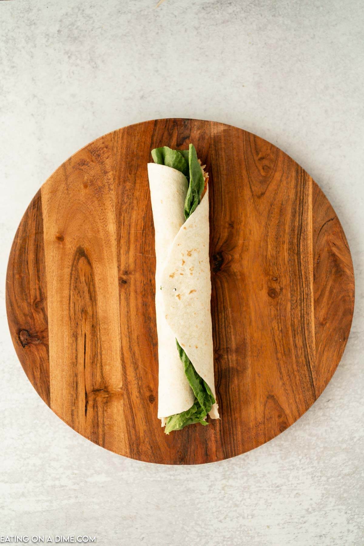 Tortilla wrapped with lettuce on a brown platter