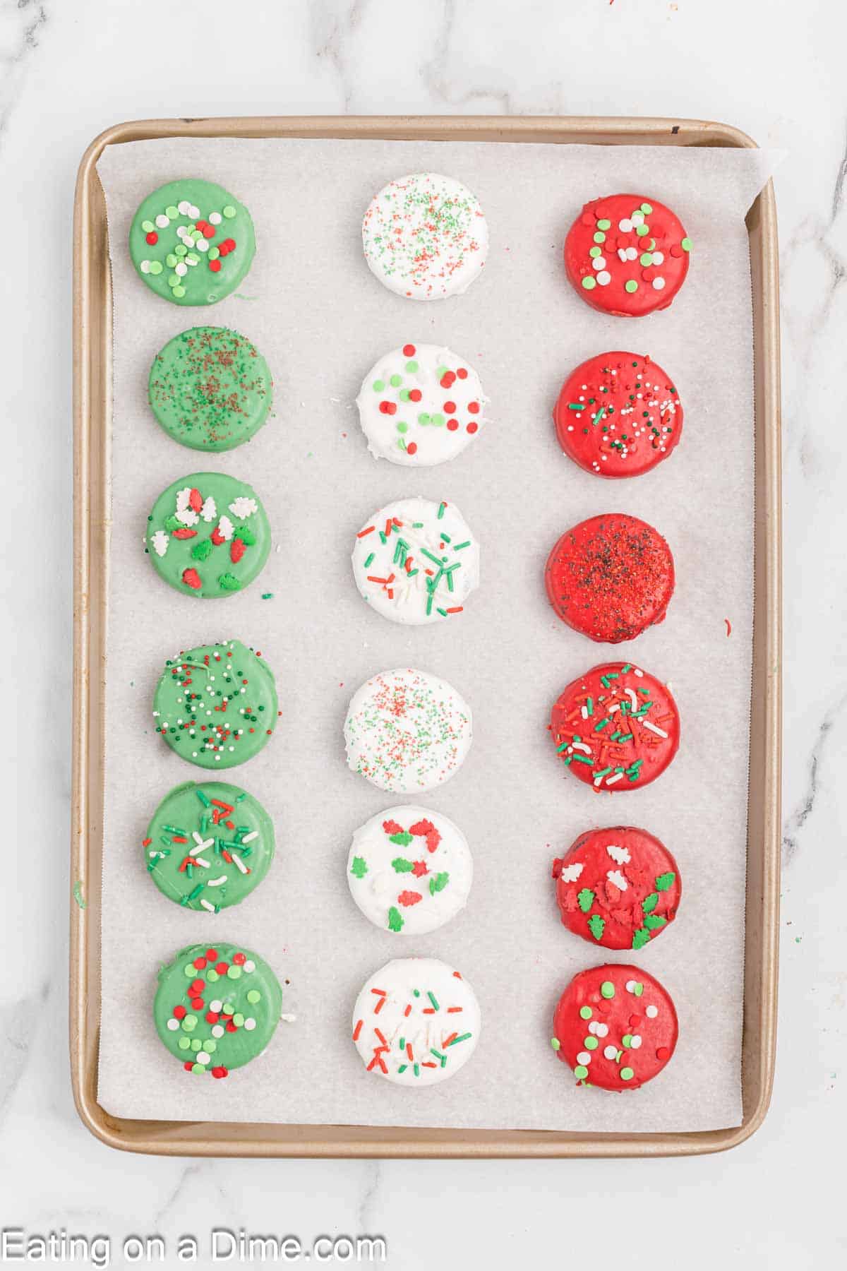 Green, White, Red Chocolate Covered Oreos on a baking sheet lined with parchment paper