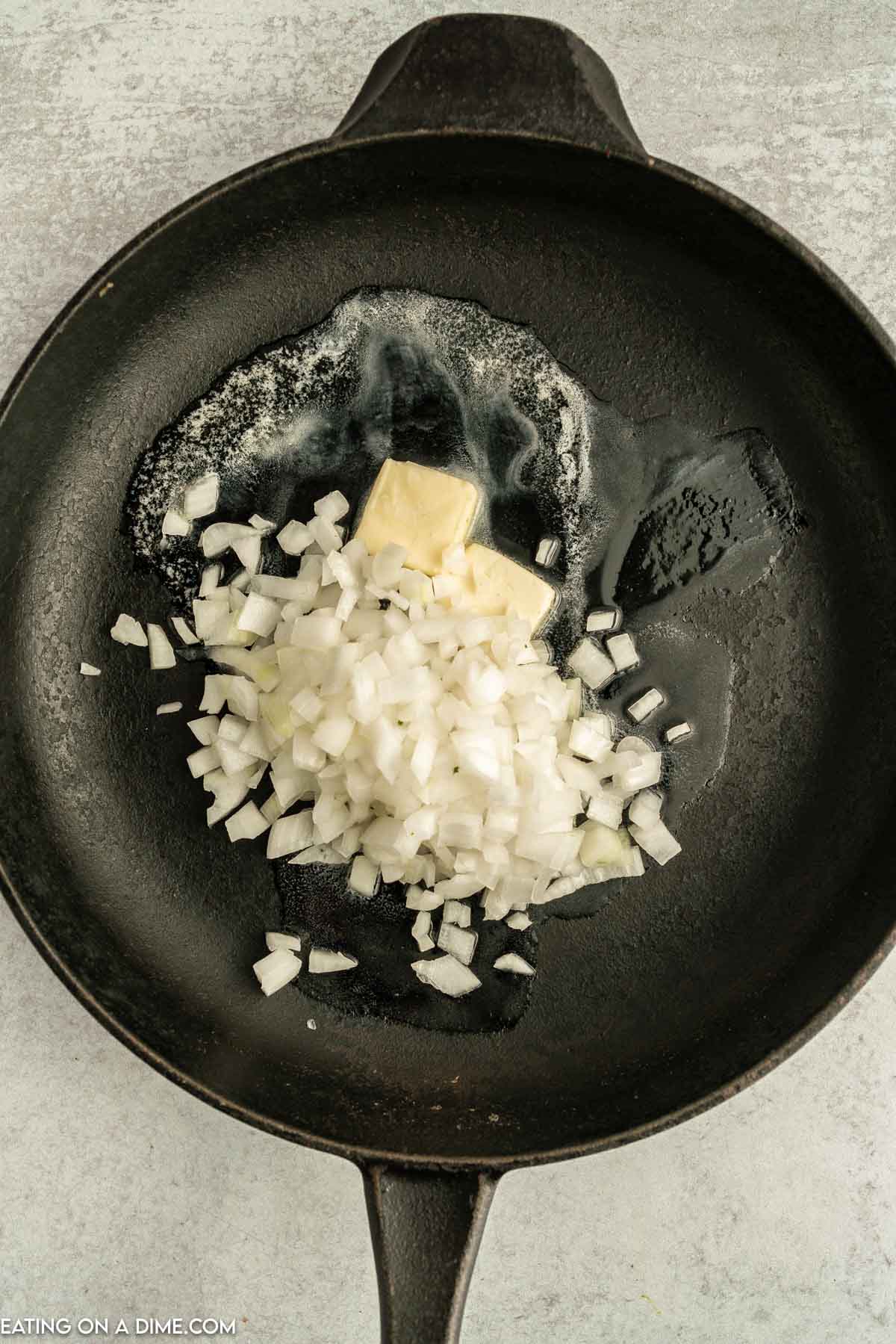 Diced onions and melted butter in a cast iron skillet