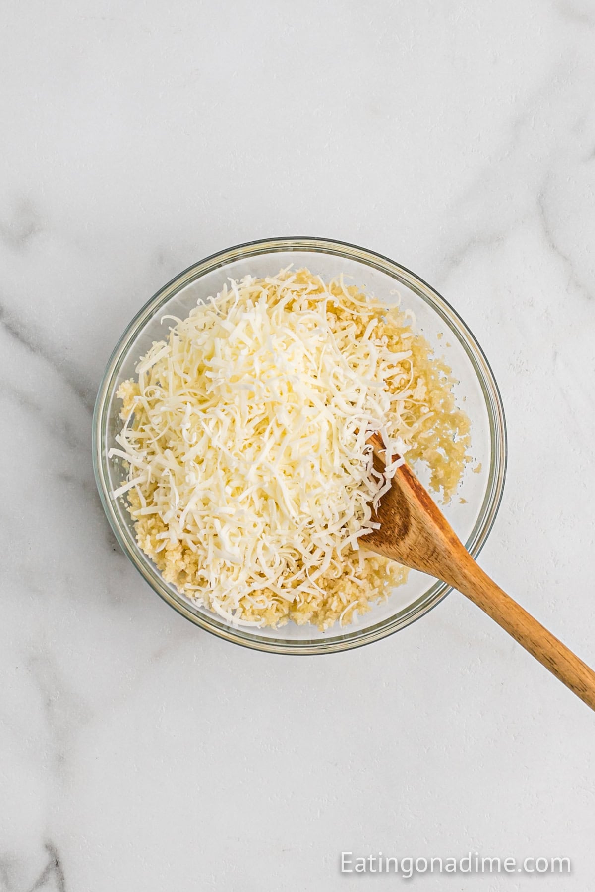 Bread crumbs in a bowl with shredded cheese