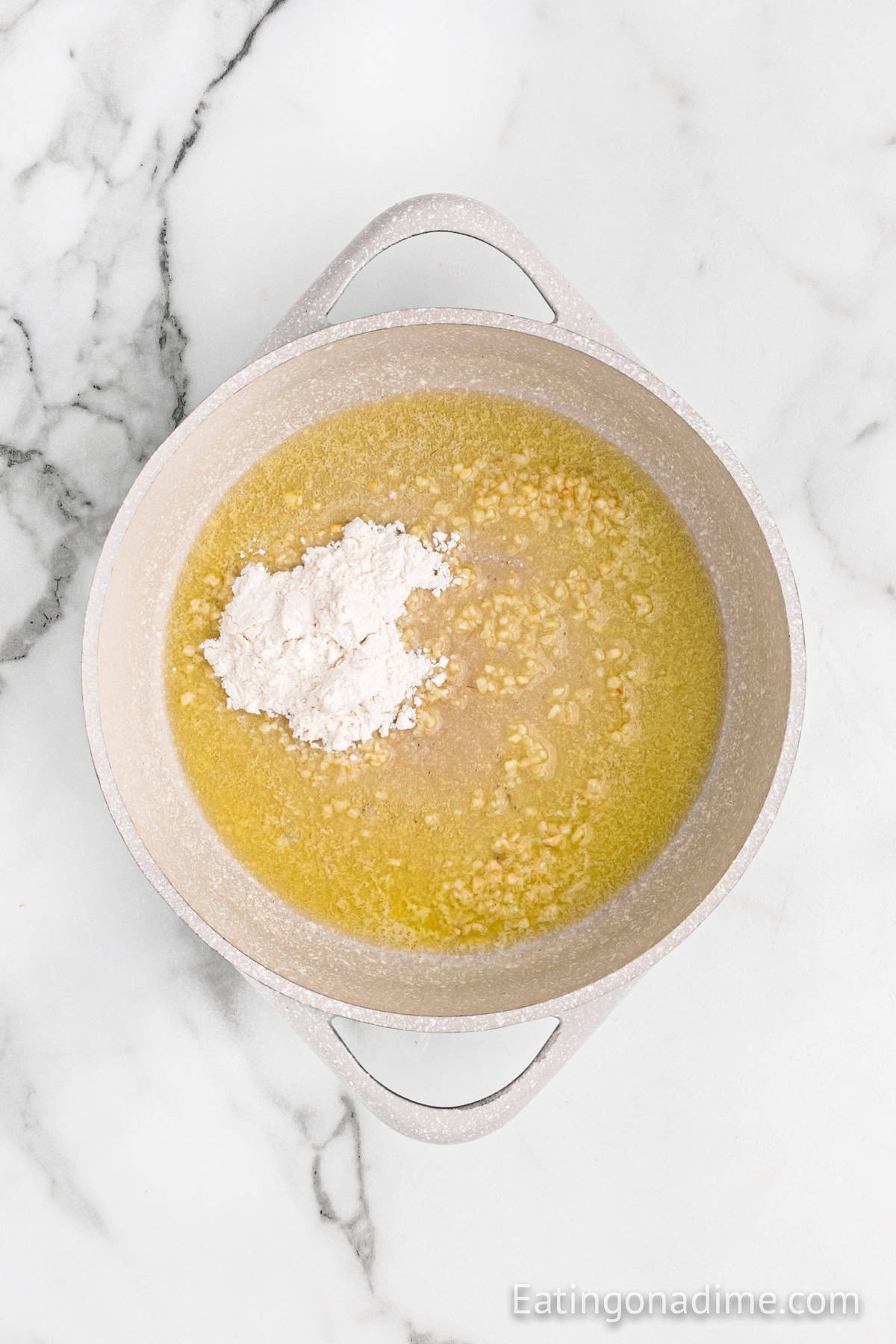 Melted butter in a large pot with minced garlic and flour