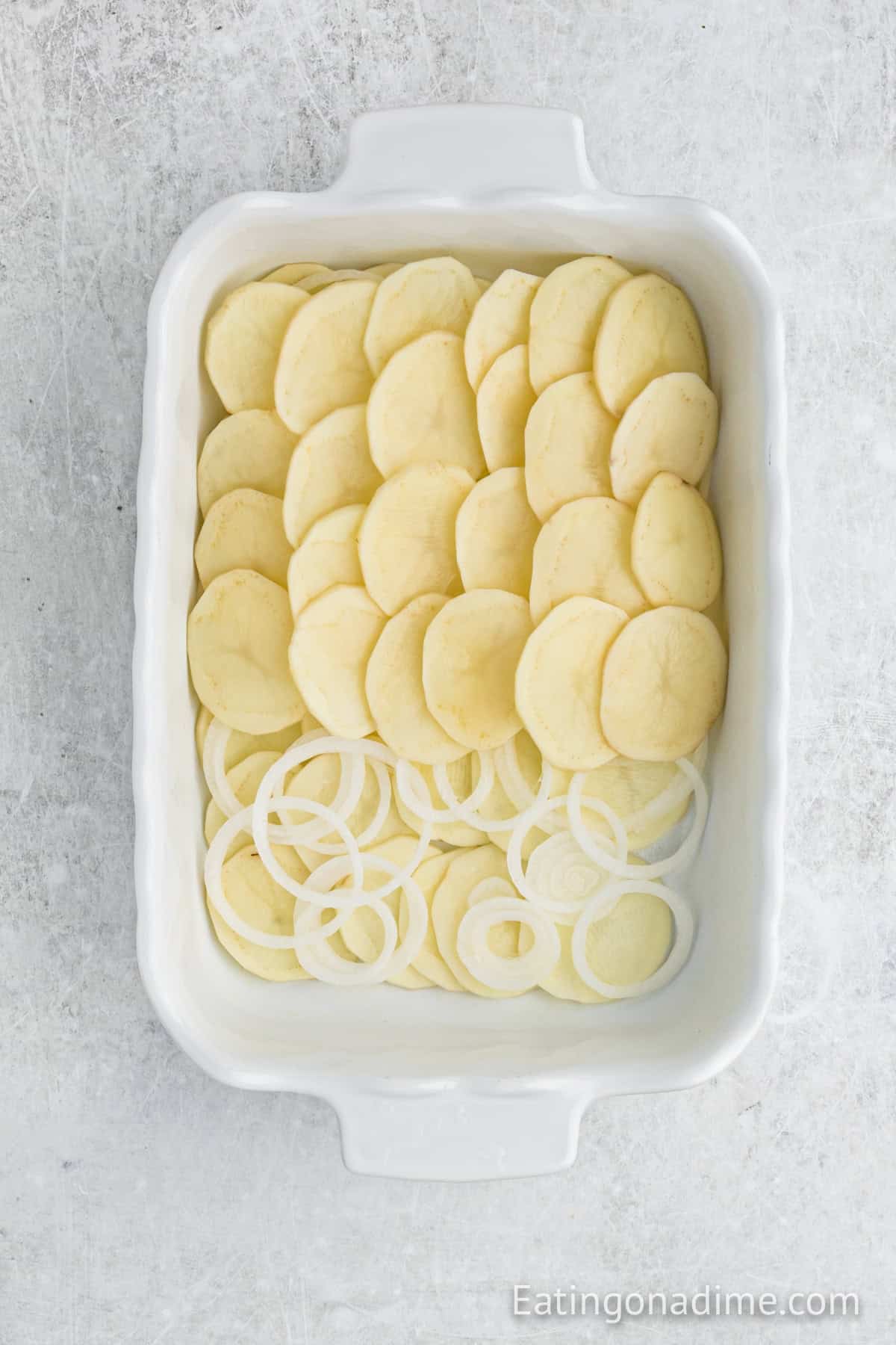 Slice potatoes and onions layered in a baking dish