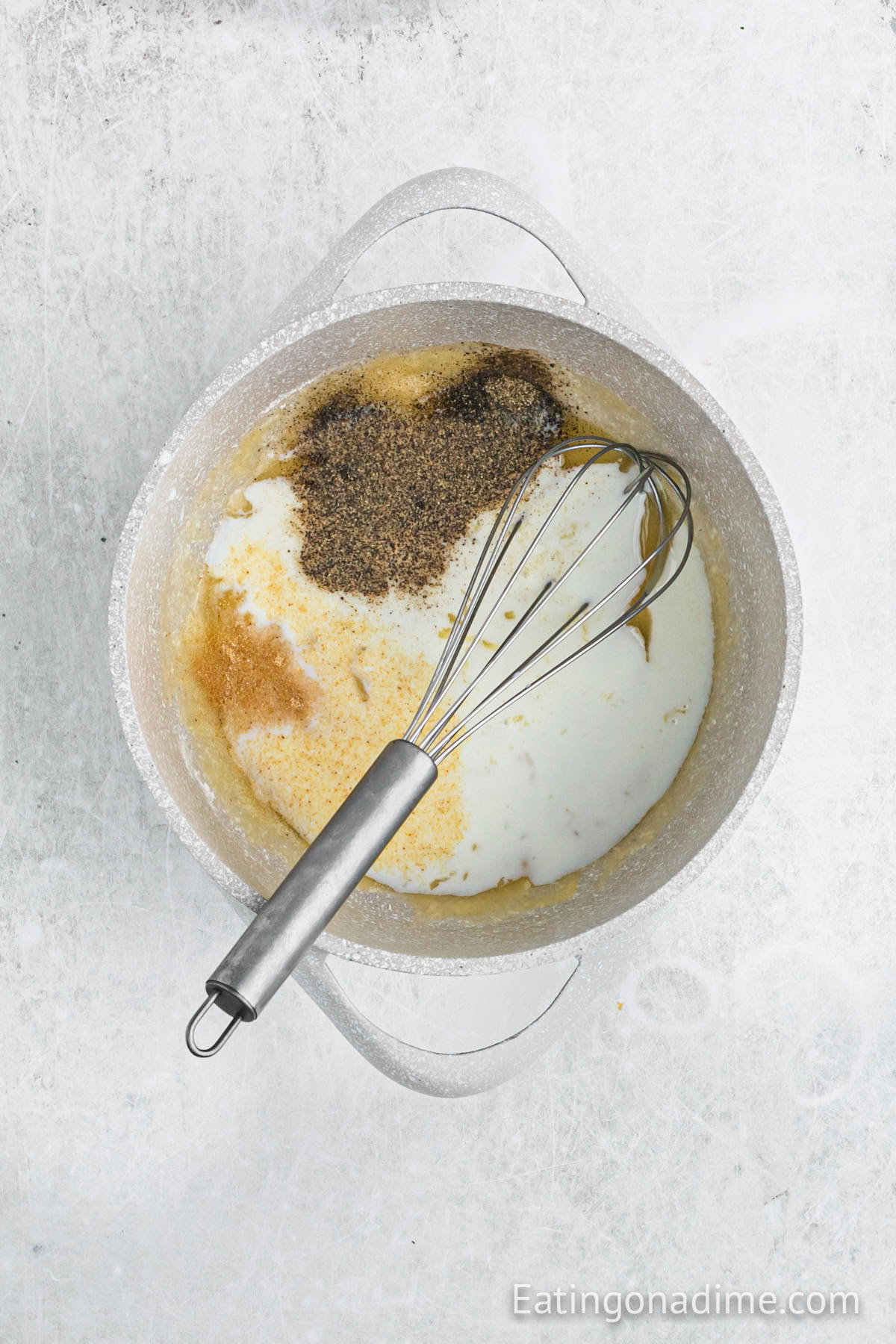 Milk, garlic powder, salt and pepper whisked in a large sauce pan