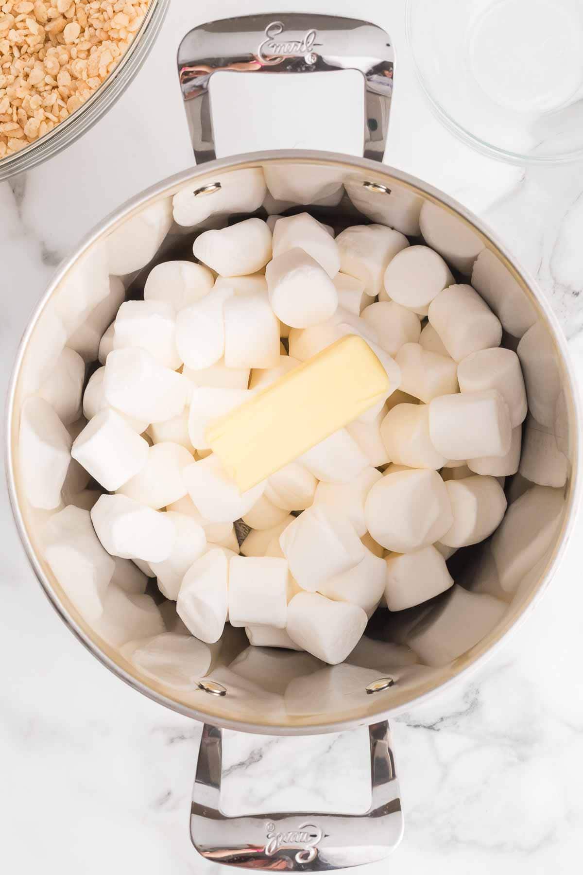 Large marshmallows in a large pot with a stick of butter