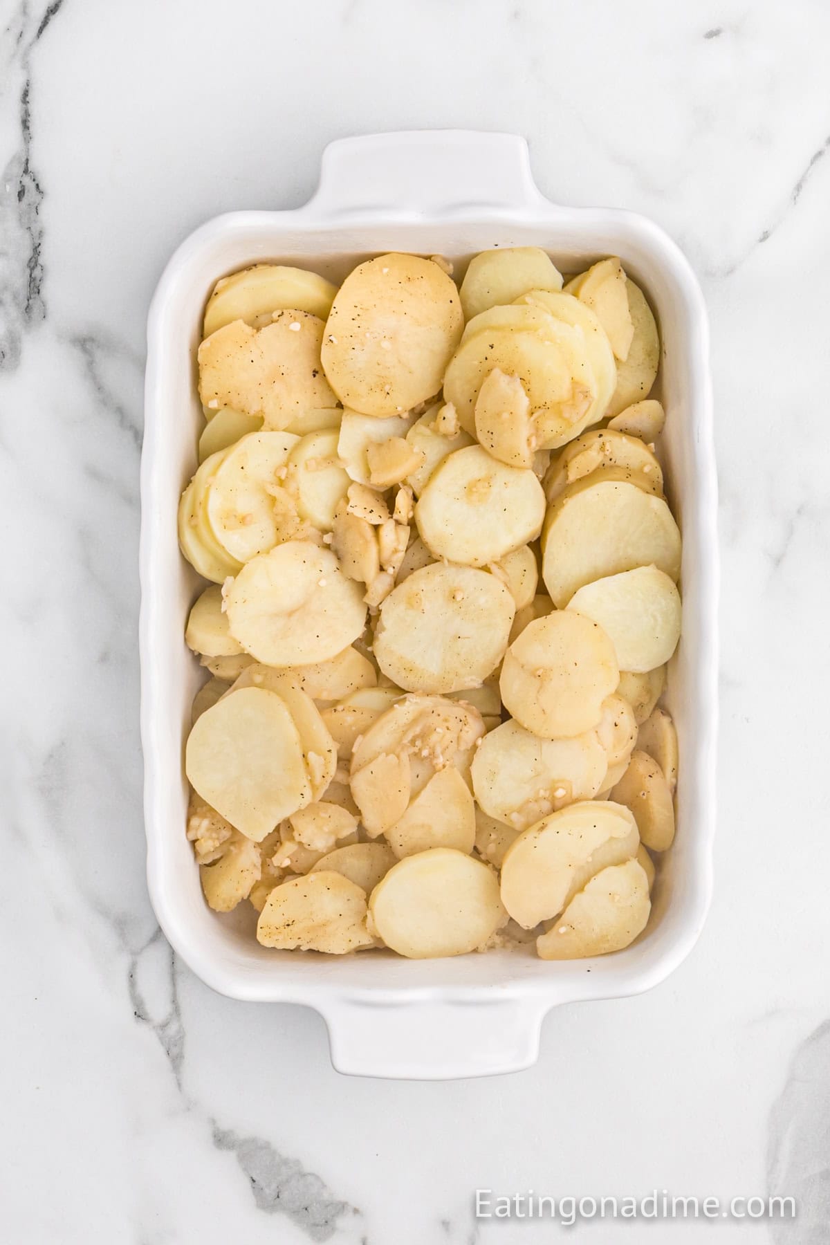 Cooked sliced potatoes in a casserole dish