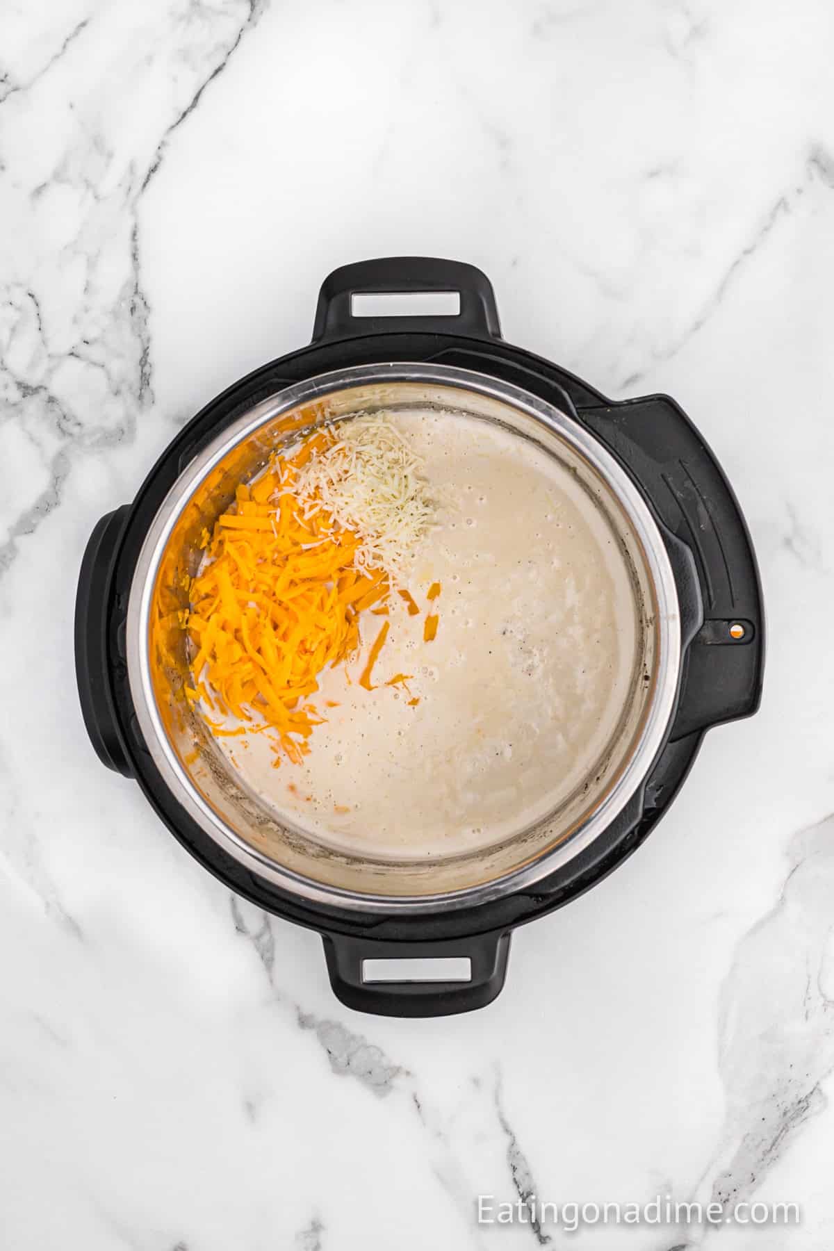 Shredded cheese added to the broth mixture into the instant pot