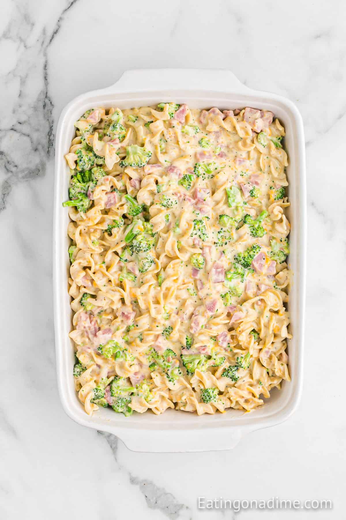 Cream noodles, broccoli and diced ham mixture poured into a baking dish