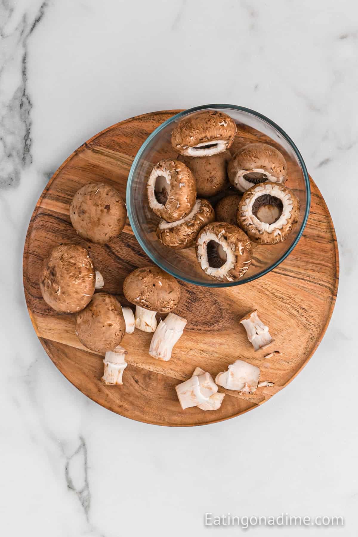 Large mushrooms in a bowl with stems removed