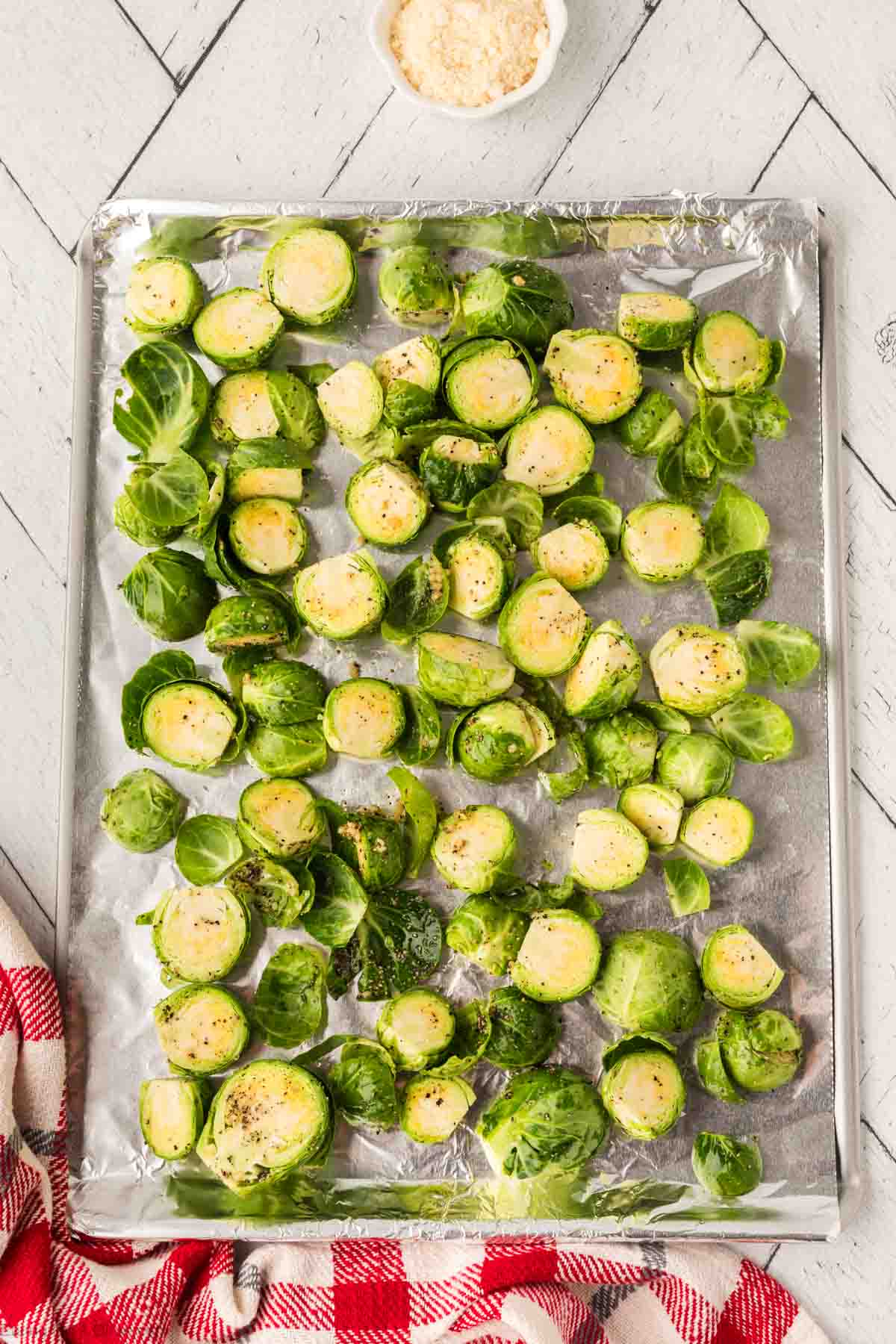 Brussel Sprouts spread on a baking sheet lined with foil