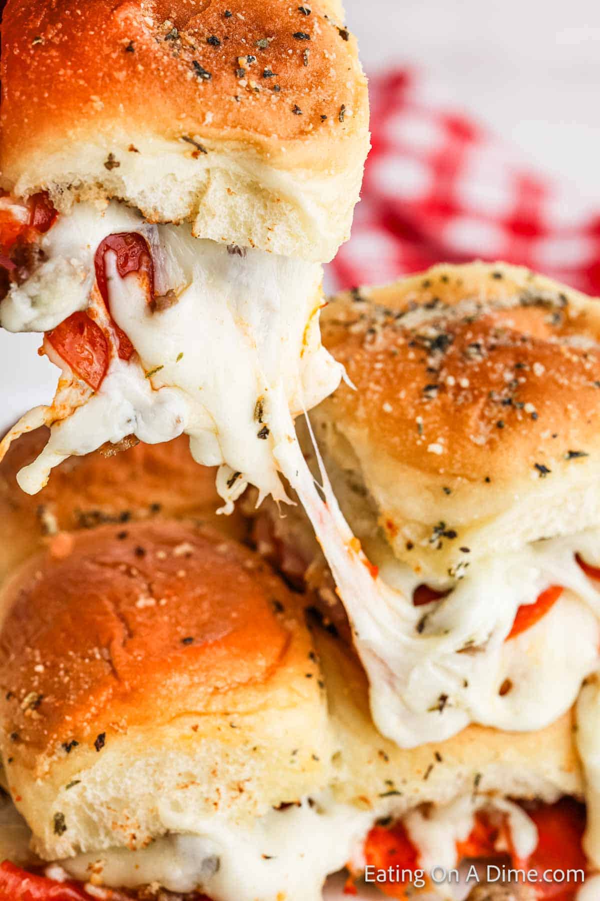 Hawaiian Roll Pizza Sliders topped with melted cheese 