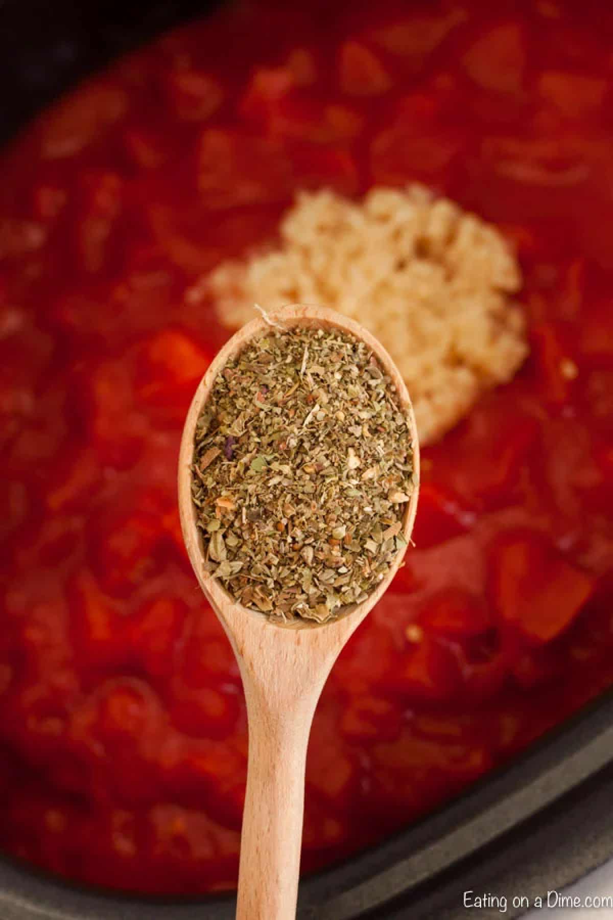 Adding seasoning to spaghetti sauce