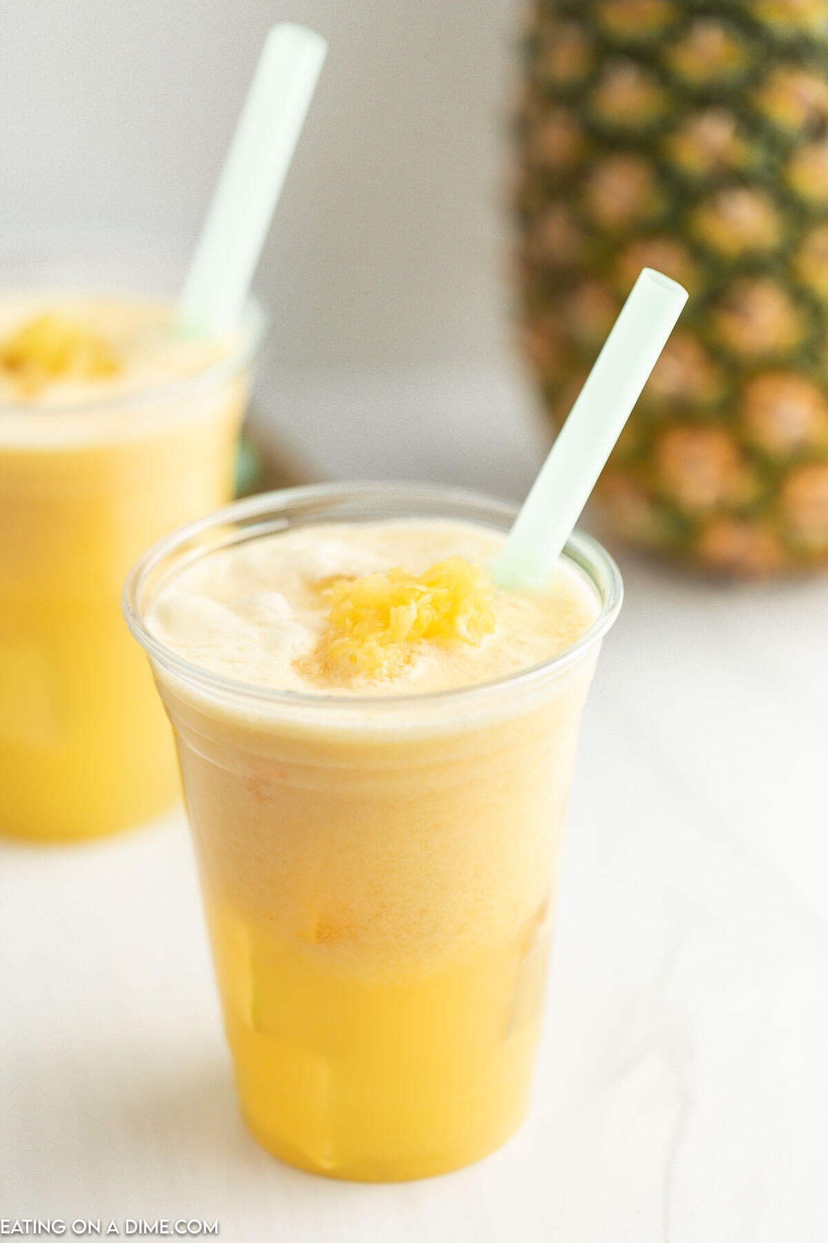 Take-away drink. Refreshing drink in a plastic cup. Pineapple