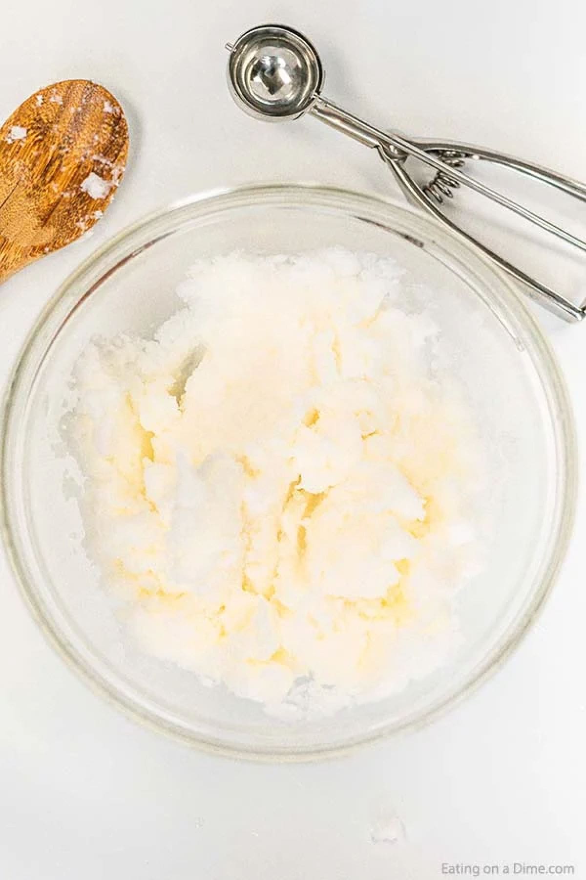 Close up image of snow ice cream being mixed in a clear bowl. 